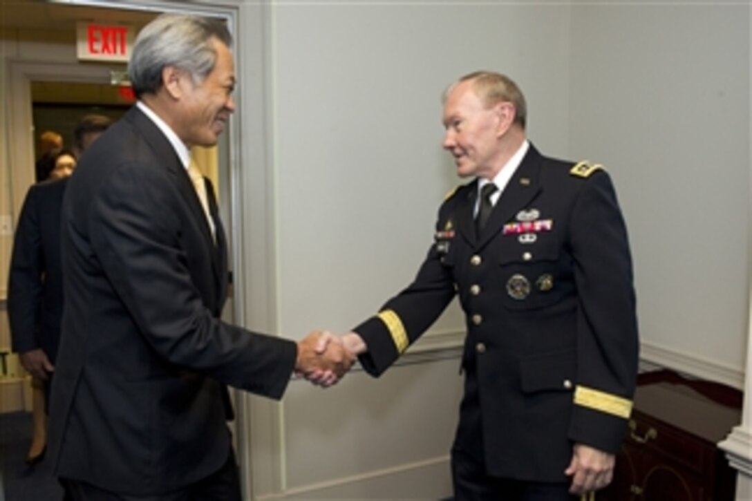 Chairman of the Joint Chiefs of Staff Gen. Martin Dempsey shakes hands with Defense Minister of Singapore Ng Eng Hen before a meeting in the Pentagon on April 4, 2012.  