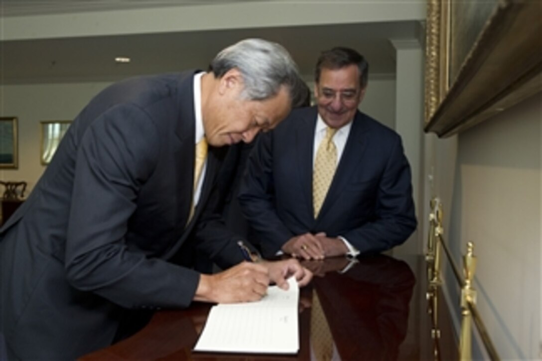 Secretary of Defense Leon E. Panetta watches as Defense Minister of Singapore Ng Eng Hen signs the guest book in the Pentagon on April 4, 2012.  