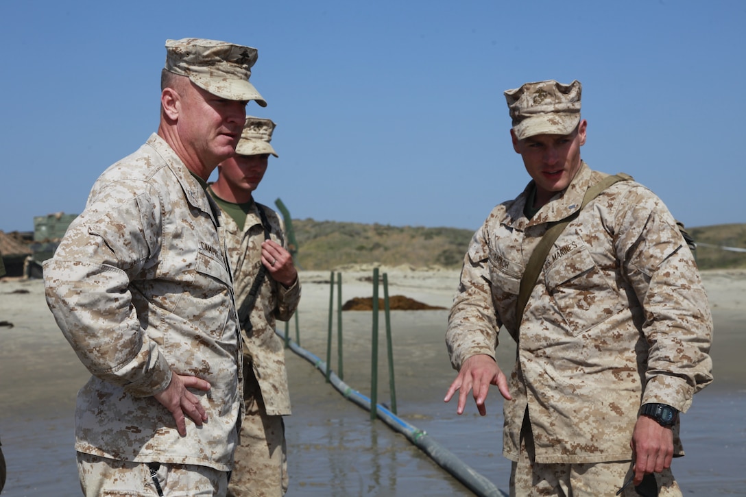 (Right) 1st. Lt. Benjamin T. Rapach, engineer detachment commander, Combat Logistics Battalion 15, 15th Marine Expeditionary Unit, gives a brief to Col. Scott D. Campbell, commanding officer, 15th MEU on how the Tactical Water Purification System works during MEU Exercise, at Red Beach, April 5. During the exercise, the 15th MEU is using roughly 1,000 gallons a day for drinking and cooking. Using the TWPS, the daily requirement was produced in just about one hour. Rapach, 25, is from Marion Center, Pa.