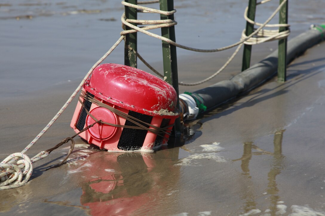 The dolphin strainer is the first piece the receiving water goes through before being filtered by the Tactical Water Purification System. The TWPS is an integral part of Marine Expeditionary Unit Exercise, held here, April 2-12. During the exercise, the 15th MEU is using roughly 1,000 gallons a day for drinking and cooking. Using the TWPS, the daily requirement was produced in just about one hour.