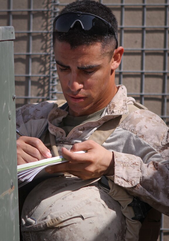 Corporal Ricardo J. Figueroa, an electrician and noncommissioned officer in charge of Marine Corps Integrated Maintenance Management System serving with Utilities Platoon, Regimental Combat Team 5, inspects a generator here used by Marines serving with 2nd Battalion, 9th Marine Regiment, April 5, 2012. Figueroa, a native of Temecula, Calif., is responsible for maintaining generators and air conditioning units used by four Marine  battalions currently operating in southern Helmand province.