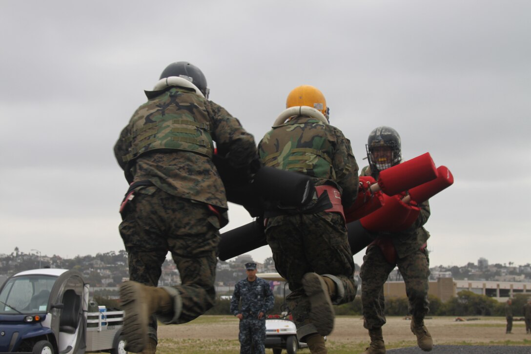 Two recruits ambush another Company E recruit during Pugil Sticks Two April 5 aboard Marine Corps Recruit Depot San Diego. This pugil sticks session is done on a small bridge and the winner is the one who lands the first fatal blow. The recruits are taught prior what constitutes a fatal blow.