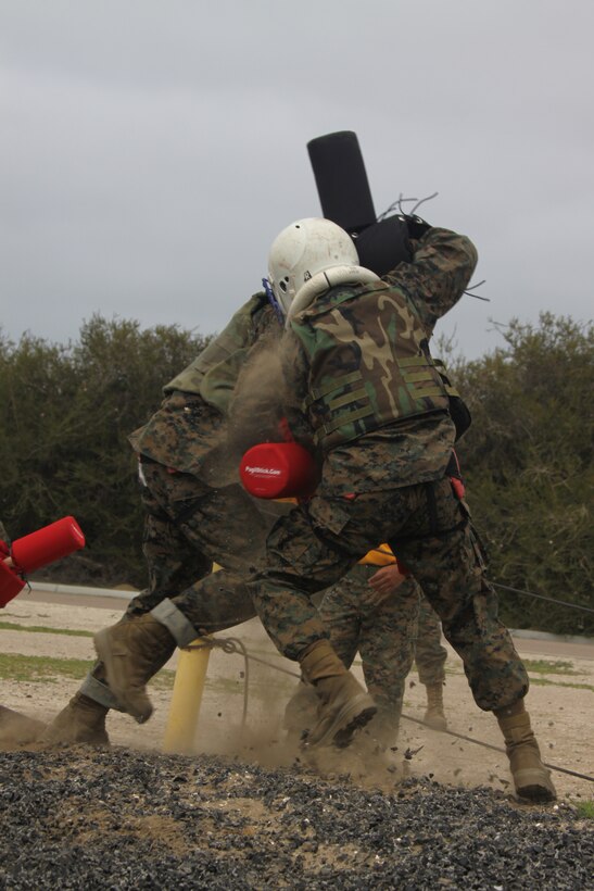 Company E recruits bout it out, two-on-one April 5 aboard Marine Corps Recruit Depot San Diego during Pugil Sticks Two. Recruits are given helmets and gear for their safety. The pugil sticks simulate their M-16 A4 service rifle with a bayonet attached. This gives recruits a feel for close-combat.