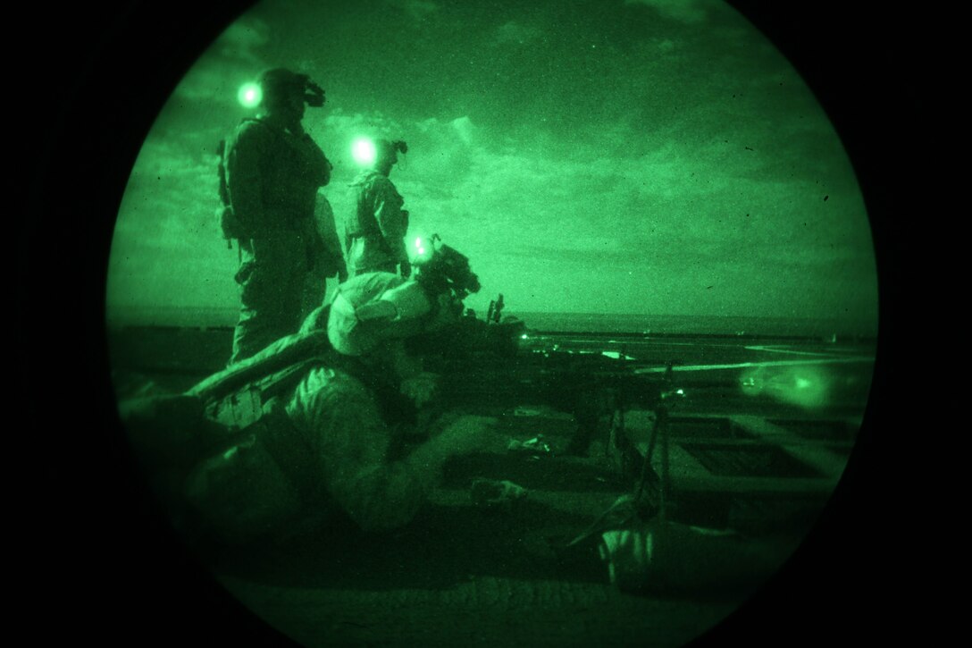 Cpl. Richard Hardeman, a rifleman with Charlie Company, Battalion Landing Team 1st Battalion, 2nd Marine Regiment, 24th Marine Expeditionary Unit, fires an M-249 squad automatic weapon during nighttime live-fire training on the ship’s flight deck as he sails across the Atlantic Ocean, April 5, 2012. The 24th MEU, partnered with the Navy's Iwo Jima Amphibious Ready Group, is deploying to the European and Central Command theaters of operation to serve as a theater reserve and crisis response force capable of a variety of missions from full-scale combat operations to humanitarian assistance and disaster relief.