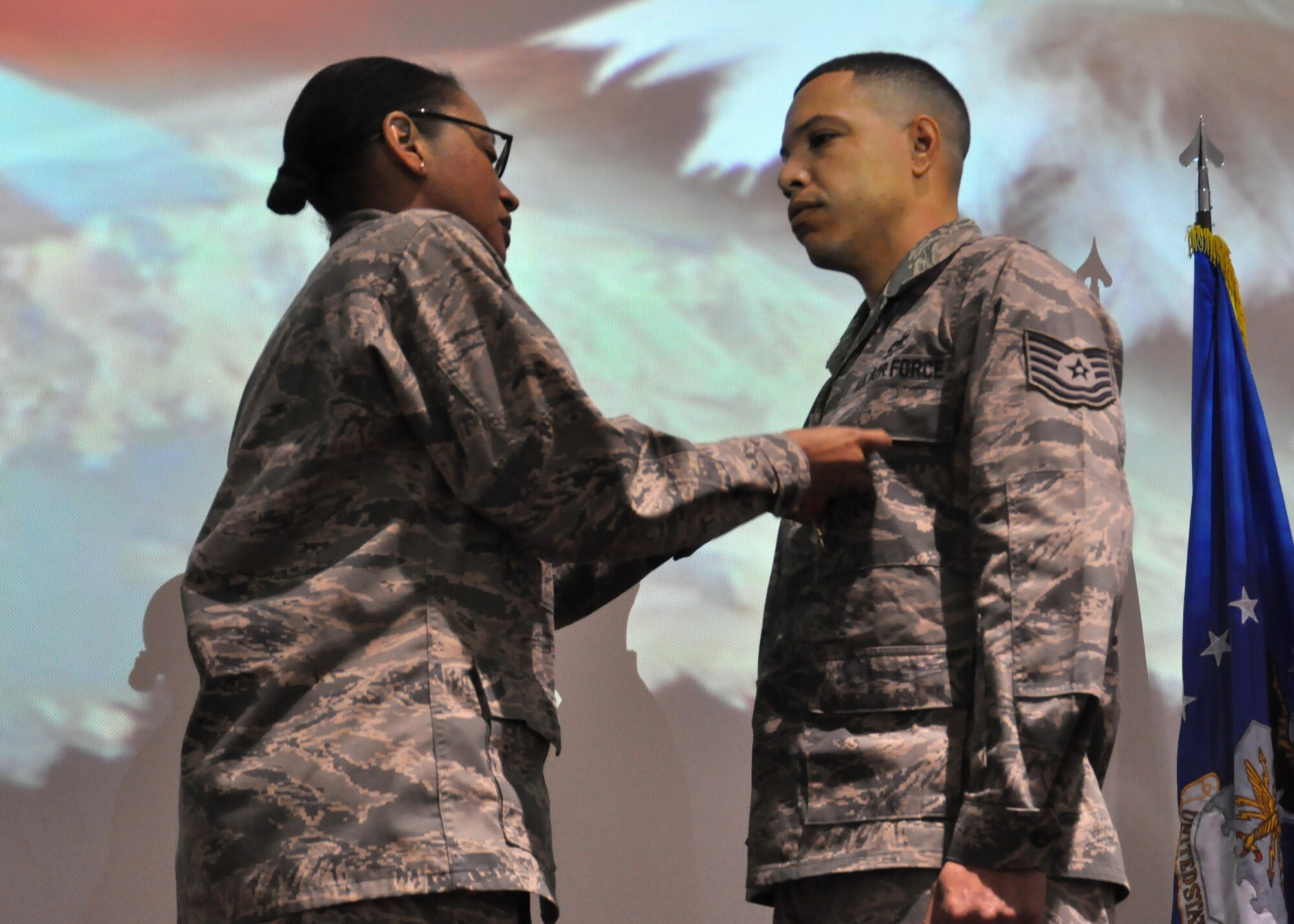 Col. Valerie Hasberry, 627th Air Base Group commander, presents Tech. Sgt. Marques Martin, 627th Logistics Readiness Squadron vehicle operator, with the Bronze Star Medal April 6, 2012, at Joint Base Lewis-McChord, Wash. Martin distinguished himself during his third six-month deployment as a convoy commander, leading troops in and out of Iraq. (U.S. Air Force photo/Senior Airman Leah Young)