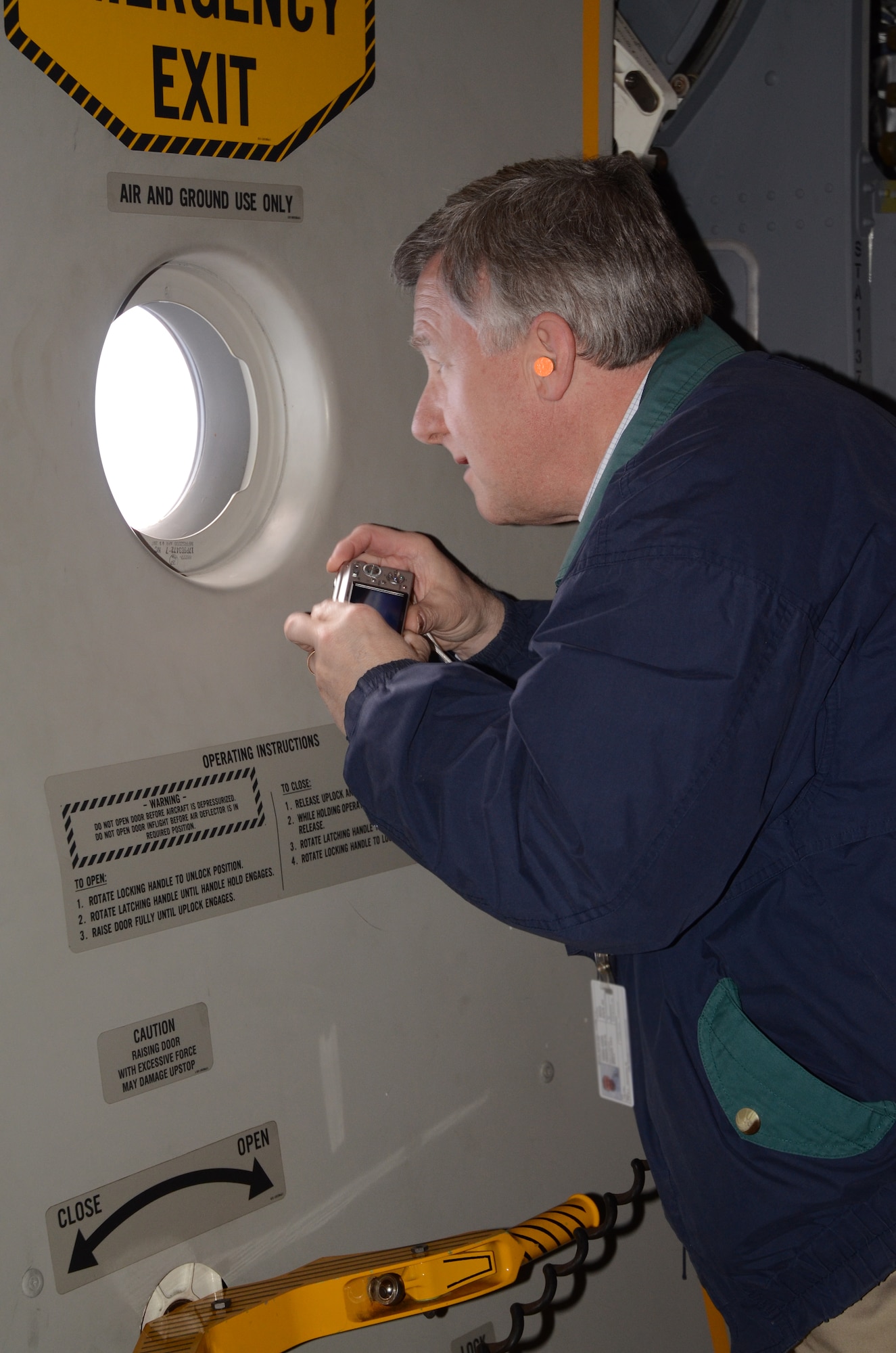 Mr. Dennis Doll, President and Chief Executive Officer of Tidewater Utilities Incorporated and 512th Civil Engineer Squadron honorary commander, takes a peak through a window during an orientation flight aboard a C-17 Globemaster III April 4, 2012. The honorary commanders of the 436th and 512th Airlift Wings came out to Dover Air Force Base, Del., for a day-long tour including a mission brief by wing commanders, a walk-through of the 436th Operations Support Squadron where they received hands-on experience with vital emergency gear, an orientation flight, a static tour of a C-5M Super Galaxy and a visit to the airlift control tower.. (U.S. Air Force photo by Staff Sgt. Dani Shea)