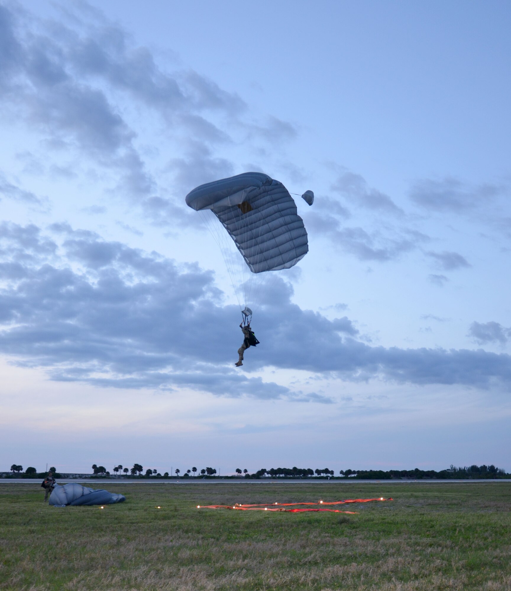 Air Force Reserve pararescueman come in for a landing after a free-fall jump here April 5. Airmen of the 920th Rescue Wing, Patrick Air Force Base, Fla., train extensively to keep current on their combat search and rescue qualifications. This includes parachuting during daylight and dusk. Pararescuemen are highly trained in parachuting, mountaineering and SCUBA and are among the most highly trained emergency trauma specialists in the U.S. military. With this medical and rescue expertise, PJs are able to perform life-saving missions in the world?s most remote areas. (U.S. Air Force photo/2nd Lt. Leslie Forshaw)