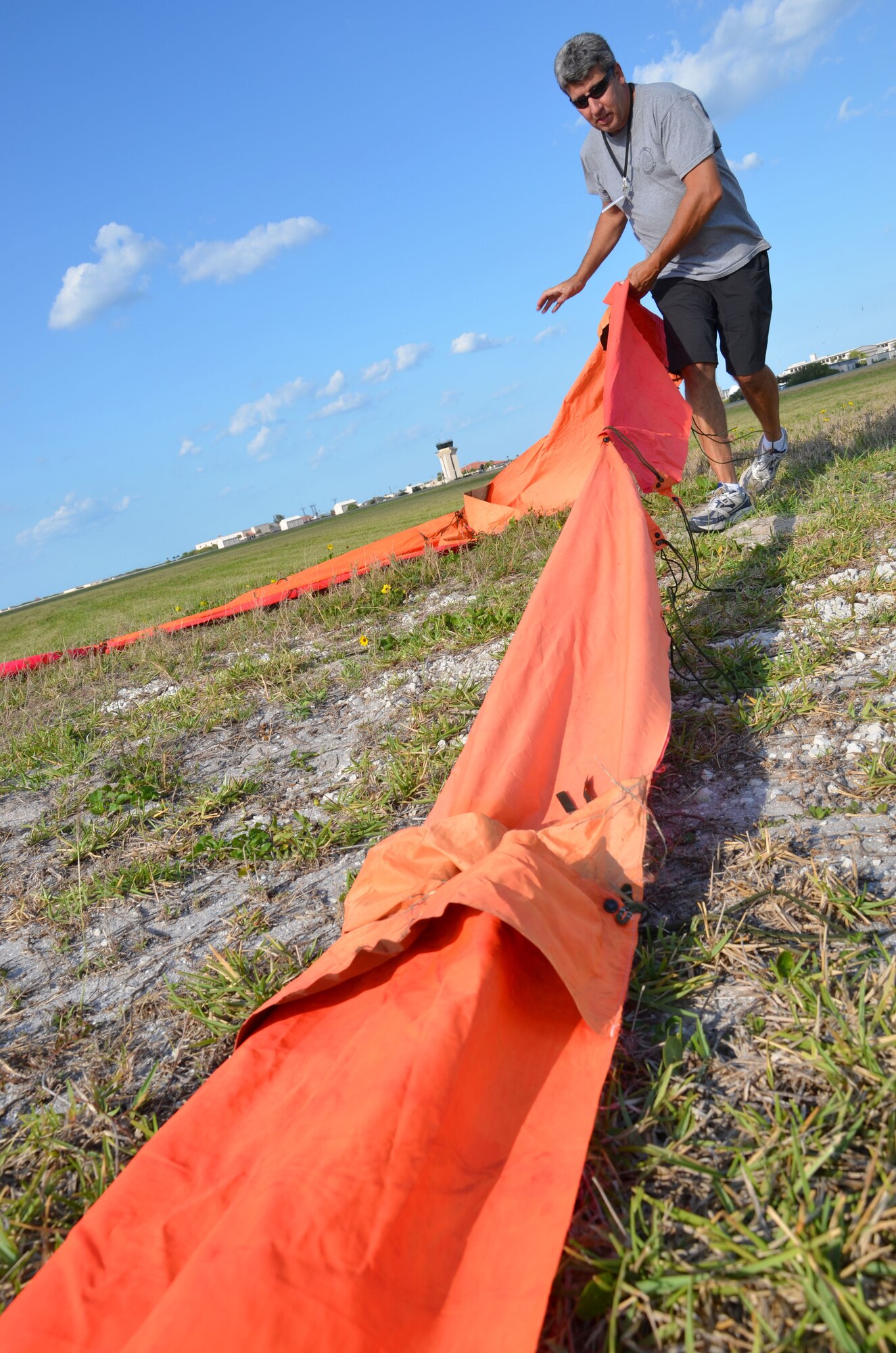 Tech. Sgt. Darryl Perron, Air Force Reserve parachute rigger, sets up a marker that is used to show wind direction and a landing spot for parachutists. Airmen of the 920th Rescue Wing, Patrick Air Force Base, Fla., train extensively to keep current on their combat search and rescue qualifications. This includes parachuting during daylight and dusk. Pararescuemen are highly trained in parachuting, mountaineering and SCUBA and are among the most highly trained emergency trauma specialists in the U.S. military. With this medical and rescue expertise, PJs are able to perform life-saving missions in the world?s most remote areas. (U.S. Air Force photo/2nd Lt. Leslie Forshaw)