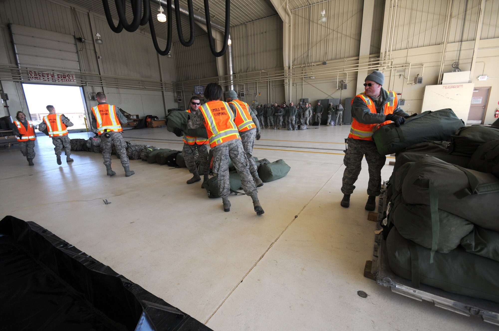 110th Airlift Wing aerial port servicemembers facilitate the arrival of U.S. Army soldiers via C-130 from the 1071st Maintenance Company on Saturday, March 10, 2012 at the Battle Creek Air National Guard Base, Battle Creek, Mich. (U.S. Air National Guard photo by Master Sgt. Sonia Pawloski/released)