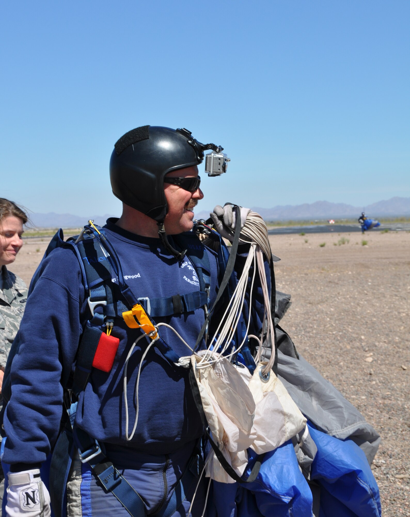 Tech Sgt. Andy Hegwood, Wings of Blue jump instructor, heads back to the hangar after performing tandem jumps with 56th and 944th Fighter Wing members.  The
Wings of Blue is the parachuting unit at the United States Air Force Academy, near Colorado Springs, Colorado.  Over the last several decades, the Wings of Blue has been one of the outstanding parachute units in the United States. Since 1967, cadets have dominated national intercollegiate parachuting, winning 21 national championships. They perform about 50 demonstrations each year, and have shown off their skills at the Copper Bowl, Fiesta Bowl, and Pro Bowl and most Air Force Falcons football games.  The team travels locally, nationally, and internationally to
perform in air shows and competitions. Their stated mission is to: "Develop Airmen through flight in its purest form--STAND IN THE DOOR!"  (U.S. Air Force photo by Staff Sgt. Denise Willhite)
