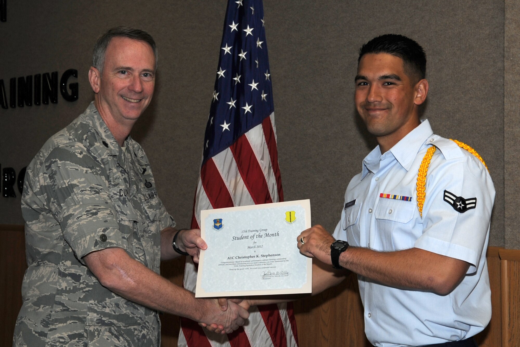 GOODFELLOW AIR FORCE BASE, Texas -- Lt. Col. Andrew Cupp, 17th Training Group Deputy Commander, presents Airman 1st Class Christopher Stephenson with the 315th Training Squadron Enlisted Student of the Month award for March, April 6. (U.S. Air Force photo/Staff Sgt. Laura R. McFarlane)