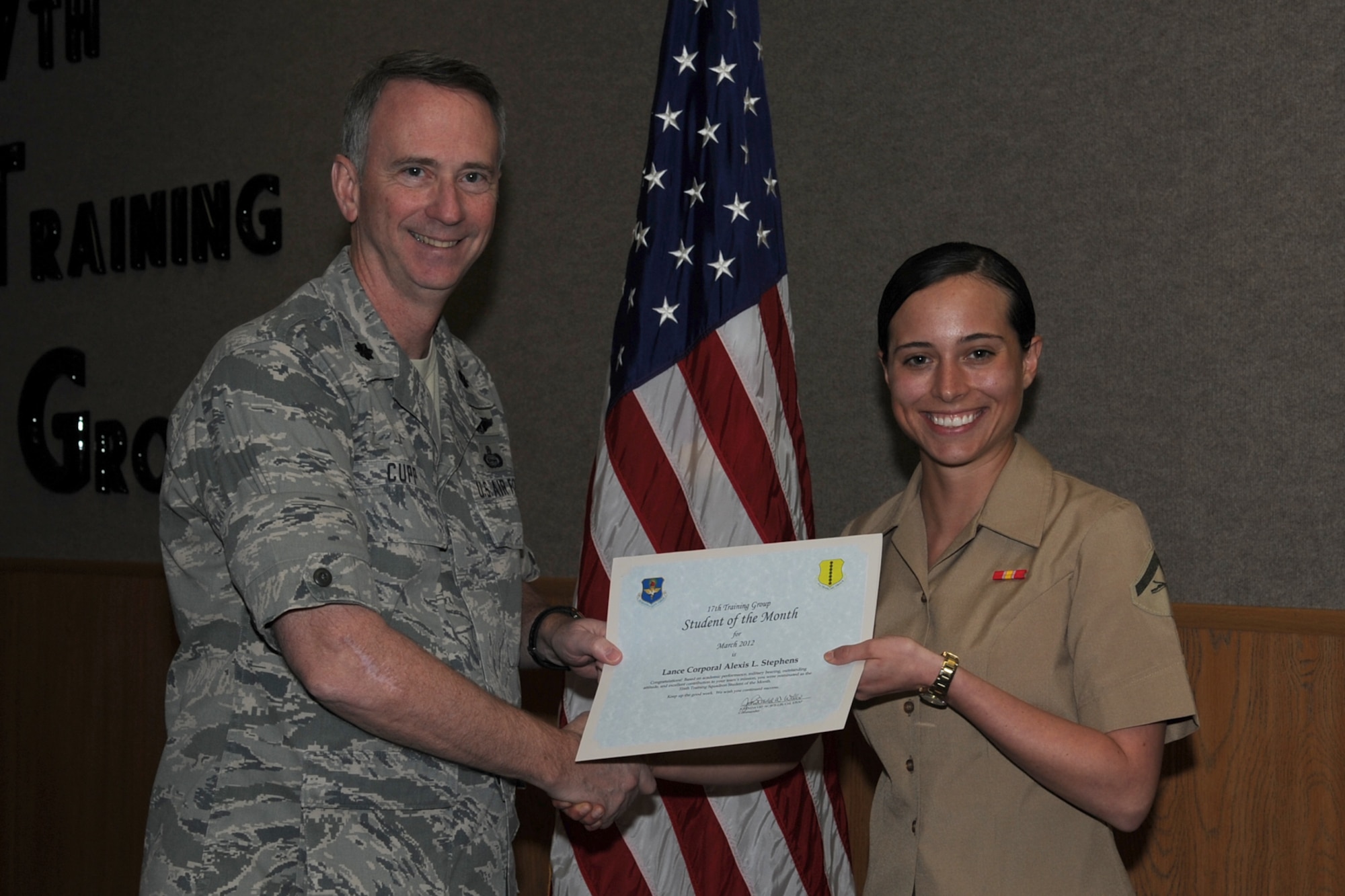 GOODFELLOW AIR FORCE BASE, Texas -- Lt. Col. Andrew Cupp, 17th Training Group Deputy Commander, presents Marine Lance Cpl. Alexis Stephens with the 316th Training Squadron Student of the Month award for March, April 6. (U.S. Air Force photo/Staff Sgt. Laura R. McFarlane)