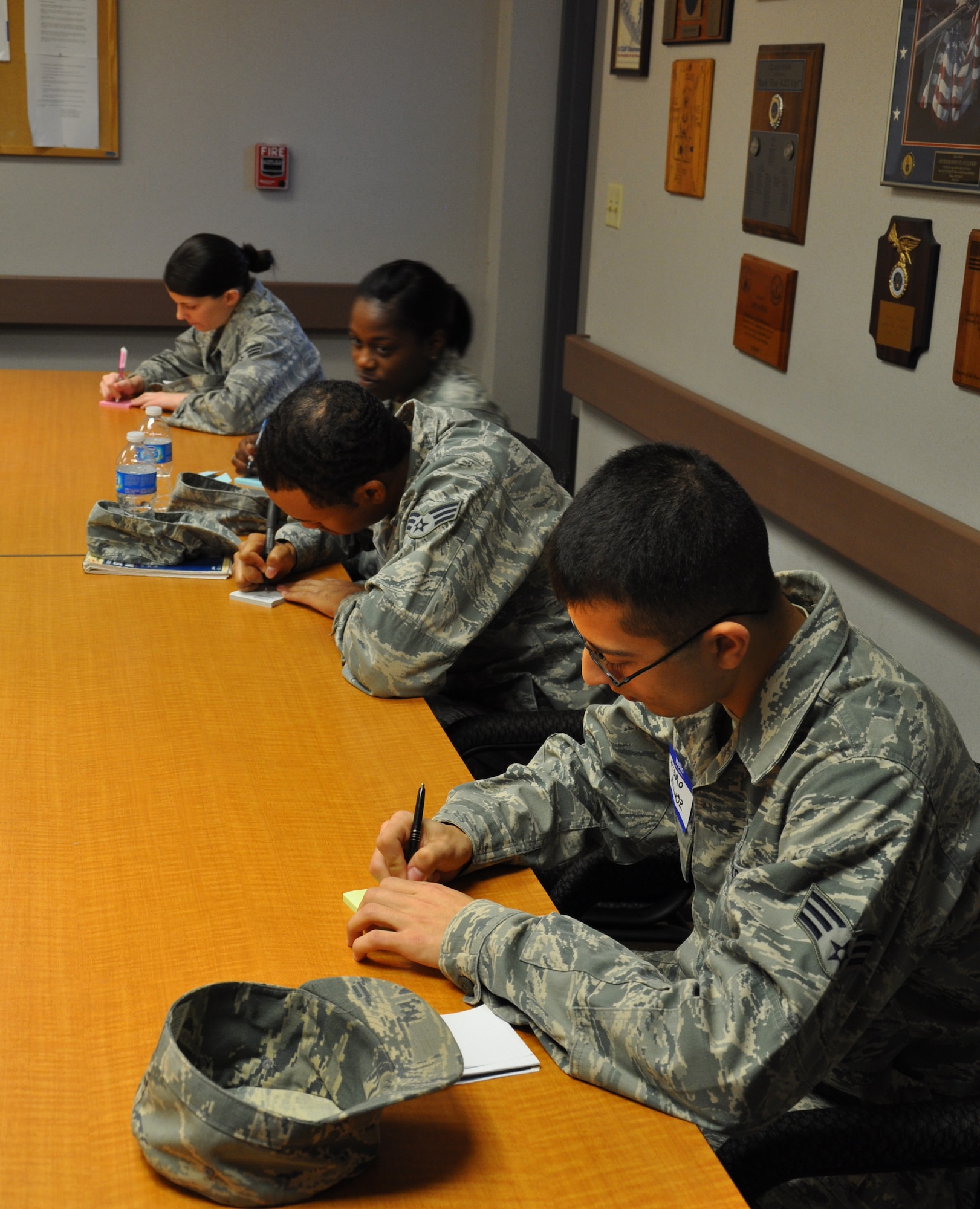 Team Beale Airmen write down concerns they would like to see addressed by wing and Air Force leadership during the Caring For People Forum at Beale Air Force Base, Calif., March 30, 2012. Issues ranged from housing allowance to after school youth programs. (U.S. Air Force photo by Staff Sgt. Robert M. Trujillo/Released) 