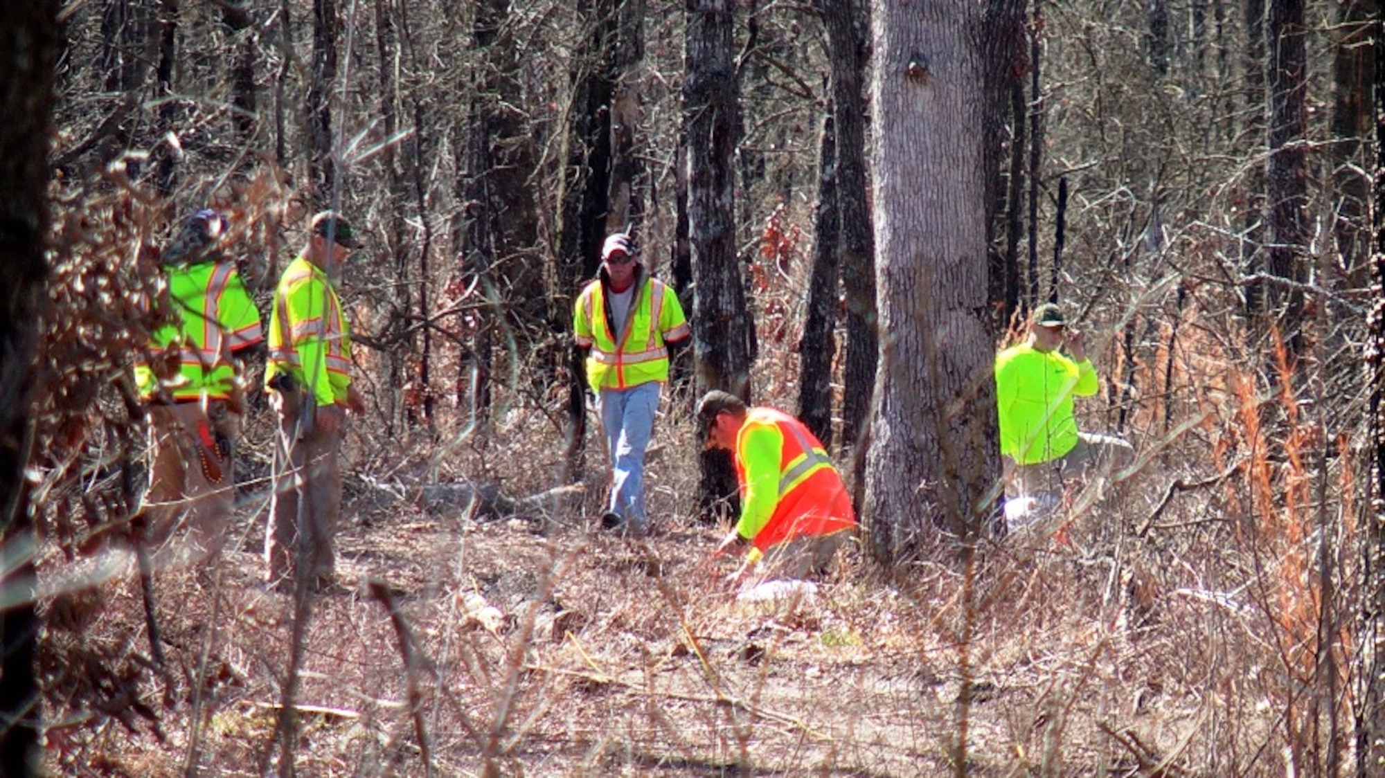 A Bay West crew prepares to perforate an inert 3-inch Stokes mortar found on Arnold AFB as part of a demonstration exercise March 6. Bay West routinely uses explosive charges on unexploded ordnance found beneath the surface of the earth south of Wattendorf Highway and east of UTSI road in an area the Army used as a practice area in the 1940s. The ordnance is placed in a hole and covered with sandbags to lessen the impact on the surrounding area, and then the pieces are recovered. (Photo by Patrick Ary)