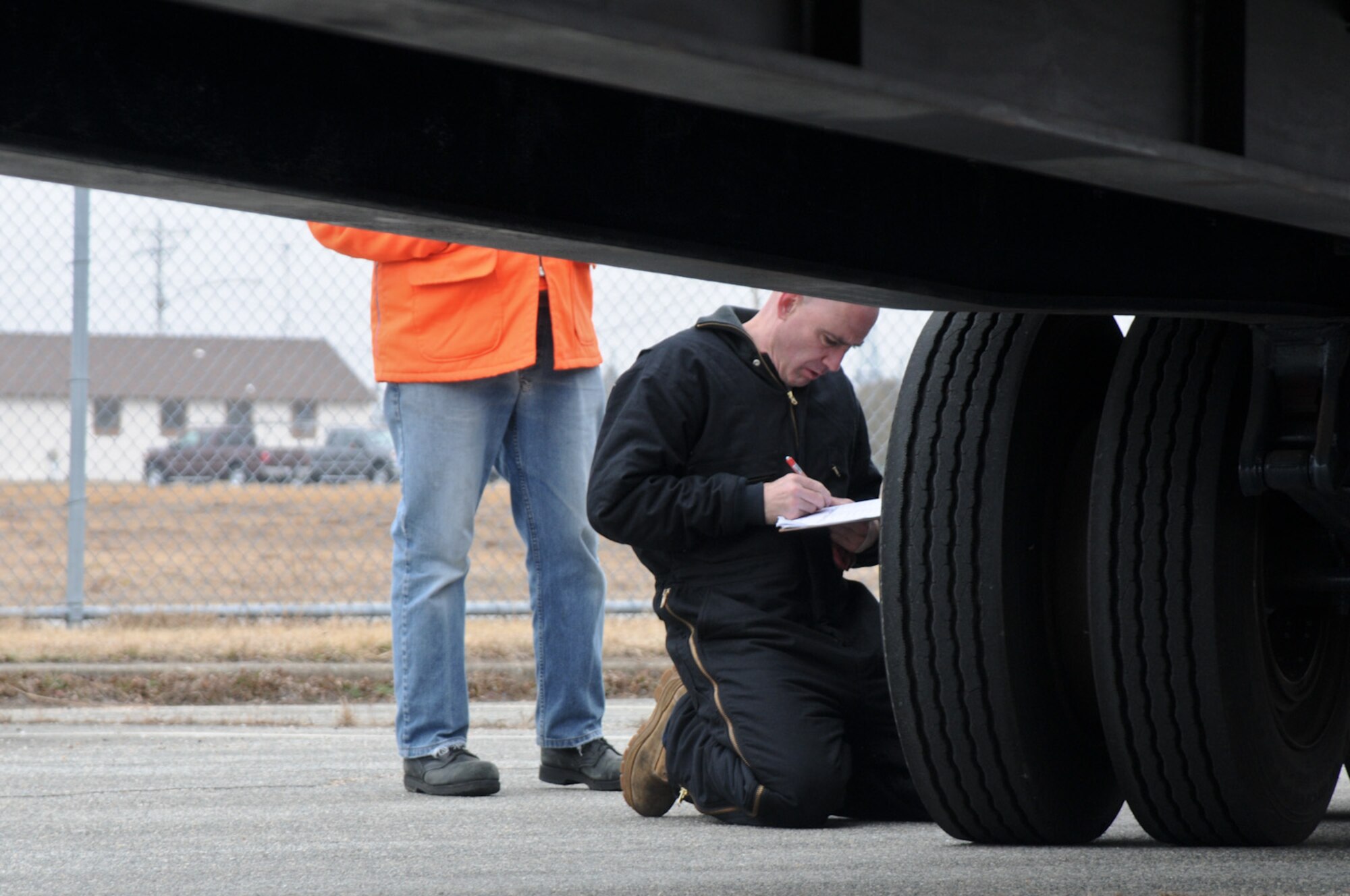 Richard Koch, 102nd Logistics Readiness Squadron, Otis Air National Guard Base, Mass., helps conduct inspections on 118 government vehicles in two days to prepare for an upcoming Logistics Compliance Inspection here, March 13. The vehicle inspection consists of fluid, tire pressure and safety checks. (National Guard photo by Tech. Sgt. Kerri Cole/Released)