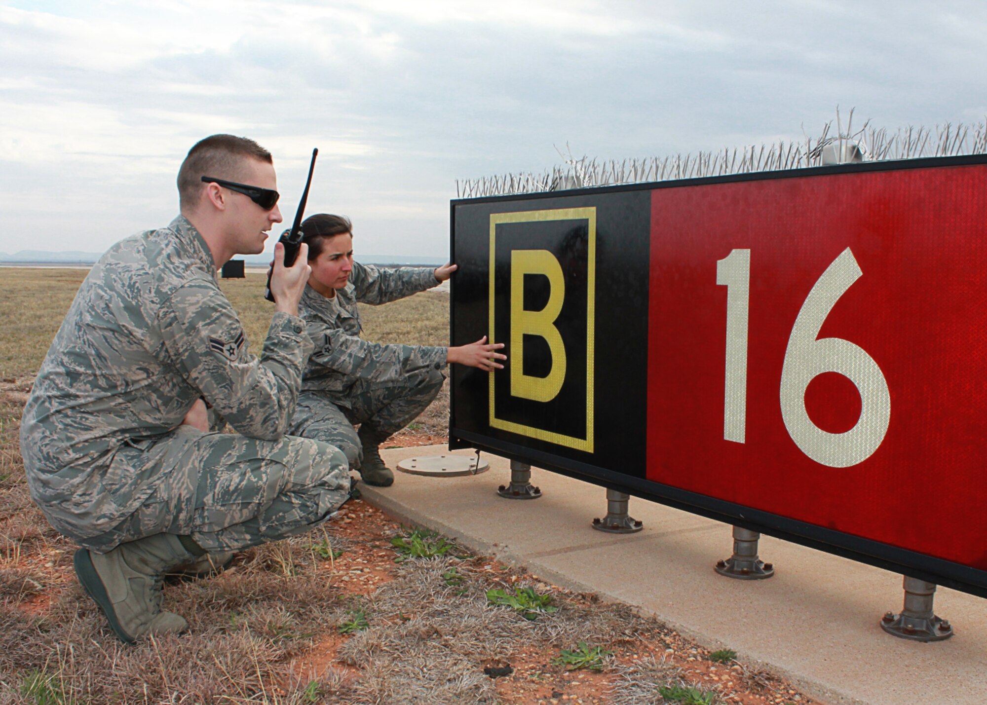Airman 1st Class Laramie Combs and Airman 1st Class Tori Reyes, 7th Operations Support Squadron, notify the Dyess airfield operations counter about airfield signage concerns during a recent air traffic system evaluation at Dyess Air Force Base, Texas. The 7th OSS Airfield Operations Flight was awarded the 2011 Air Combat Command Annual Airfield Operations Award for Airfield Management Facility of the Year for the second year in a row. (U.S. Air Force photo by Senior Airman Evan Stewart/Released)