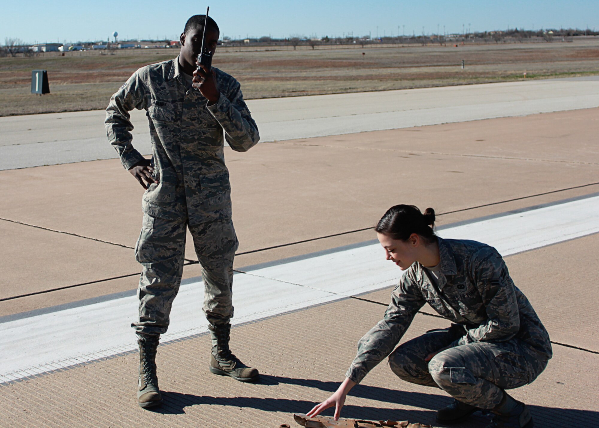 Senior Airman Aaron Henry, left, and Airman 1st Class Gabrielle Aragon, right, 7th Operations Support Squadron, notify Dyess tower about foreign object debris on the runway during a recent air traffic system evaluation at Dyess Air Force Base, Texas. The 7th OSS Airfield Operations Flight was awarded the 2011 Air Combat Command Annual Airfield Operations Award for Airfield Management Facility of the Year for the second year in a row. (U.S. Air Force photo by Senior Airman Evan Stewart/Released)