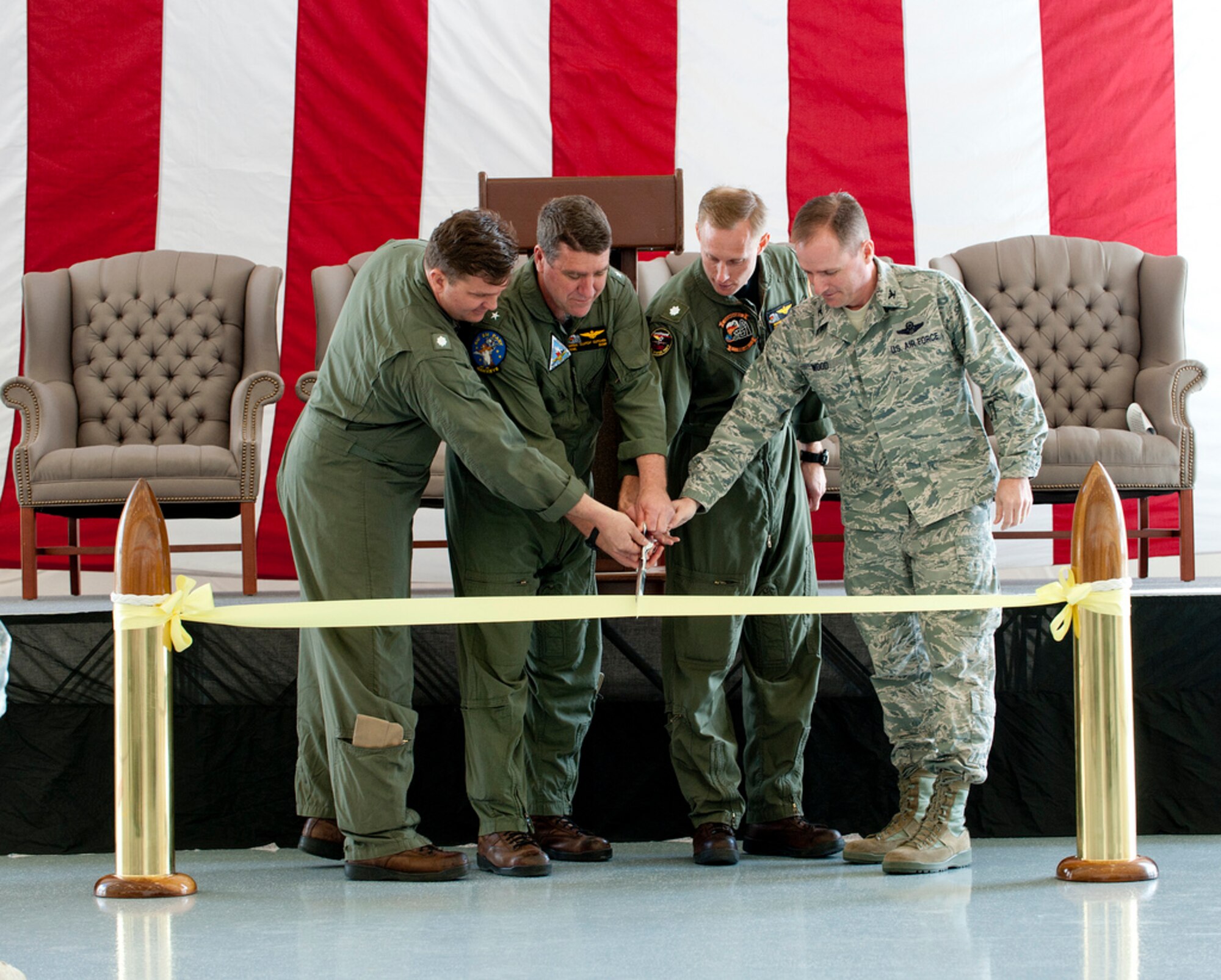 From left: Commander Chip DeWalt, VR-52 commanding officer; Rear Adm. Bryan Cutchen, Naval Reserve Forces Command deputy; Cmdr. Wayne Gunther, VR-64 commanding officer and Col. John Wood, Joint Base McGuire-Dix-Lakehurst commander, officially opened the new Navy hangar at Bldg. 3370 March 29. The hangar wil serve as the home for Navy C-9 Skytrains and C-130 Hercules. VR-64 and VR-52 both relocated 450 Sailors from Willow Grove, Pa., during a base realignment and closure. (U.S. Air Force Photo by Russ Meseroll/Released)
