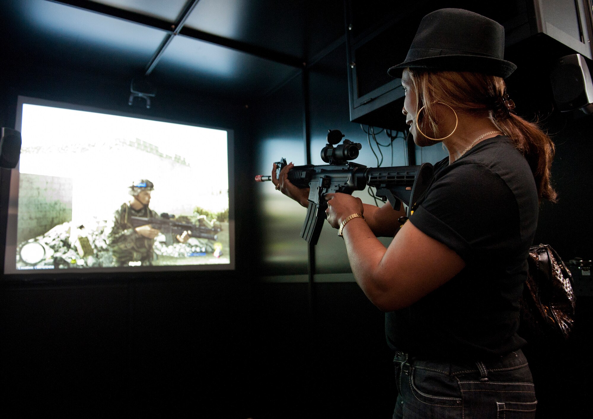 Juliet Jose, originally from Jamaica, gets hands-on experience at the New Jersey National Guard Battle Lab Combat Shooting Simulation March 23 here. The International Spouses Group also visited a C-17 Globemaster III static display and the Explosive Ordnance Disposal. The group toured various locations around Joint Base McGuire-Dix-Lakehurst. (U.S. Air Force Photo by Russ Meseroll/Released) 