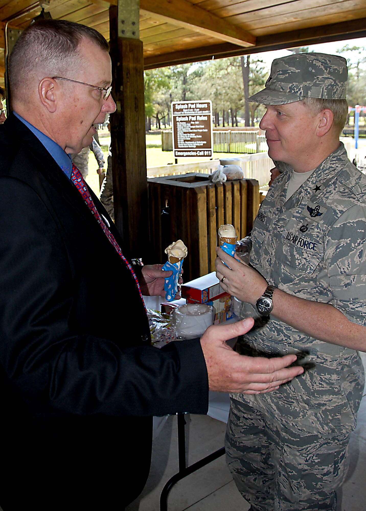 Paul McShane, the region 9 vice-president of the National Exchange Club, and Brig. Gen. David Harris, the Air Armament Center vice commander, enjoy ice cream cones following an awards ceremony at the Volunteer Appreciation Ice Cream Social April 5 at Eglin Air Force Base, Fla.  Along with McShane, the other recipients were Amy Burgess, 33rd Maintenance Squadron; Ricki McWilliams, 96th Force Support Squadron; and Nancy Gerig, a Family Services Center volunteer.  The volunteers were recognized for their efforts in the military and local communities.  (U.S. Air Force photo/Kevin Gaddie)