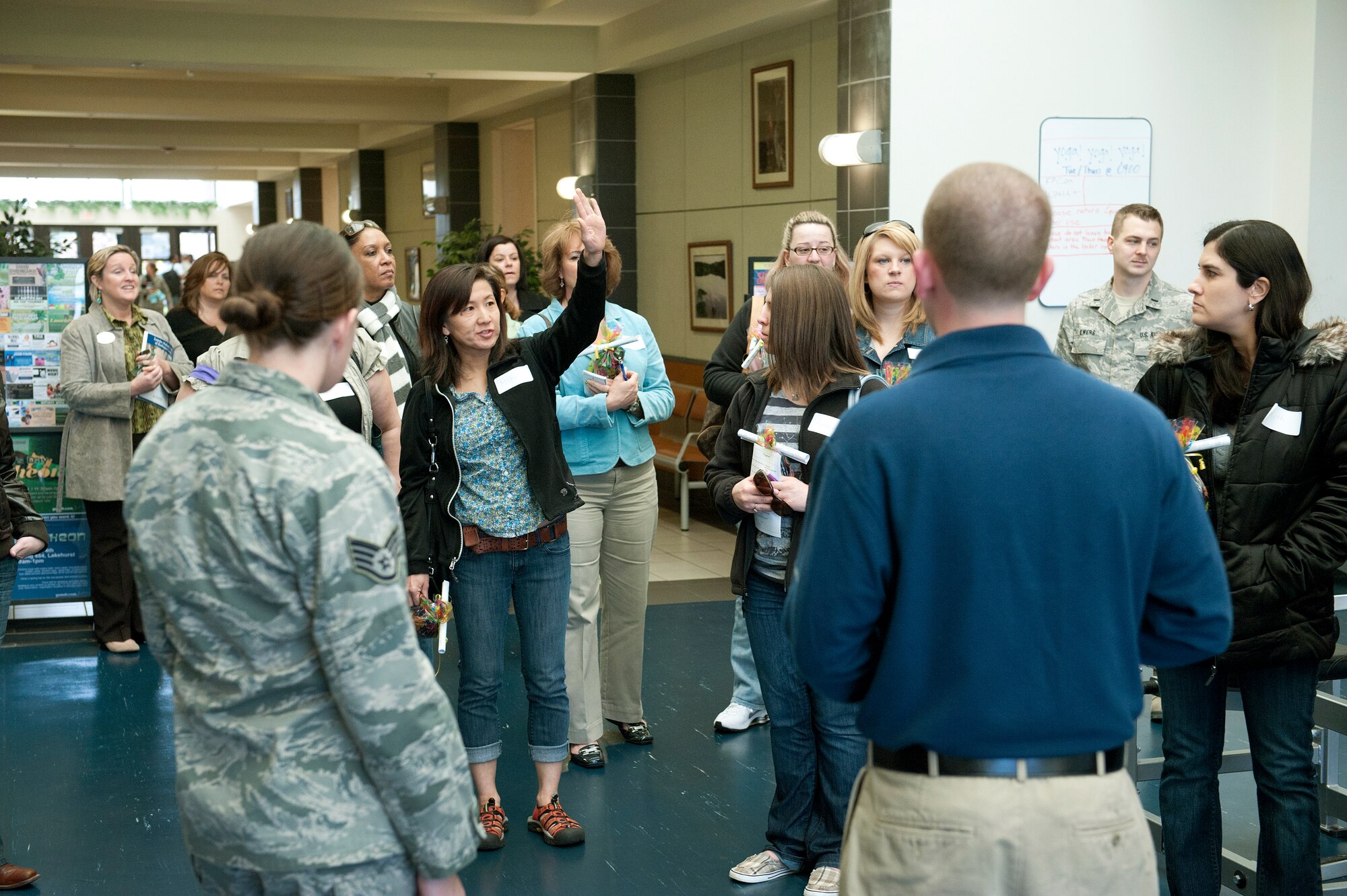 New community members ask questions at the McGuire Fitness and Sports Center during the first Joint  Base McGuire-Dix-Lakehurst Community Newcomer's Orientation Interactive bus tour March 28. This tour is an Integrated Delivery Systems Initiative and has been implemented to increase access and use of JB MDL services and facilities. A group of 15 militry spouses participated in the tour which will be held monthly. Information on upcoming dates and times will be posted on the joint base public website, www.jointbasemdl.af.mil, and in the baes newspaper. (U.S. Air Force Photo by Russ Meseroll/Released)