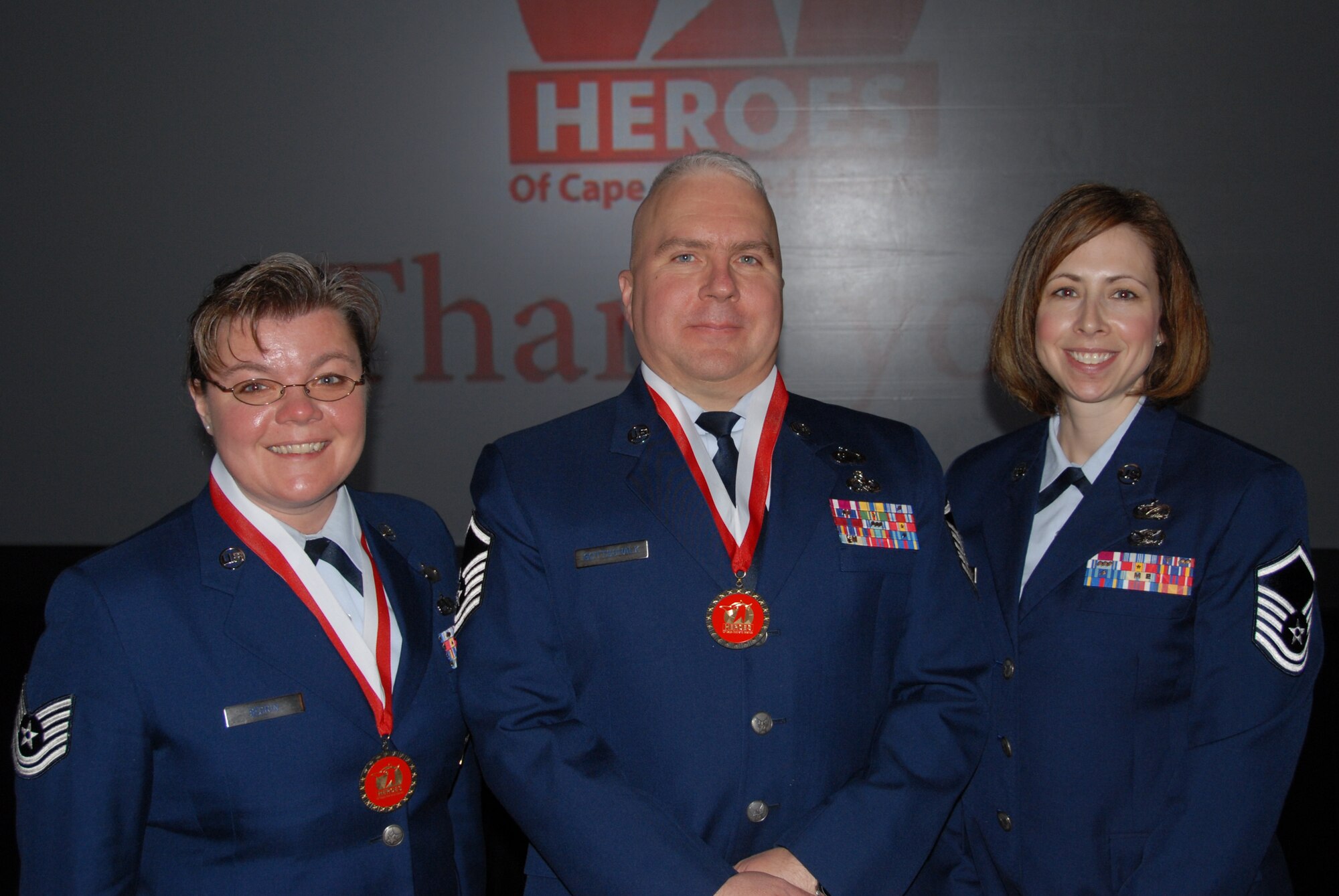 Master Sgt. Guy Gottschalk and Tech. Sgt. Dixie Segrin, membes of the 102nd Intelligence Wing, were honored as 2011 Military Good Samaritan heroes during the 10th Annual Cape Cod and Islands Heroes breakfast at The Resort and Conference Center in Hyannis, Mass., March 30, 2012. Gottschalk and Segrin voluntarily provided lifesaving support to four teenagers after an automobile accident, March 24, 2011.  Gottschalk and Segrin were nominated for the recognition by Master Sgt. Jennifer Lovering.  Pictured left to right are Segrin, Gottschalk and Lovering.  (National Guard photo by Capt. Evan Lagasse/Released)