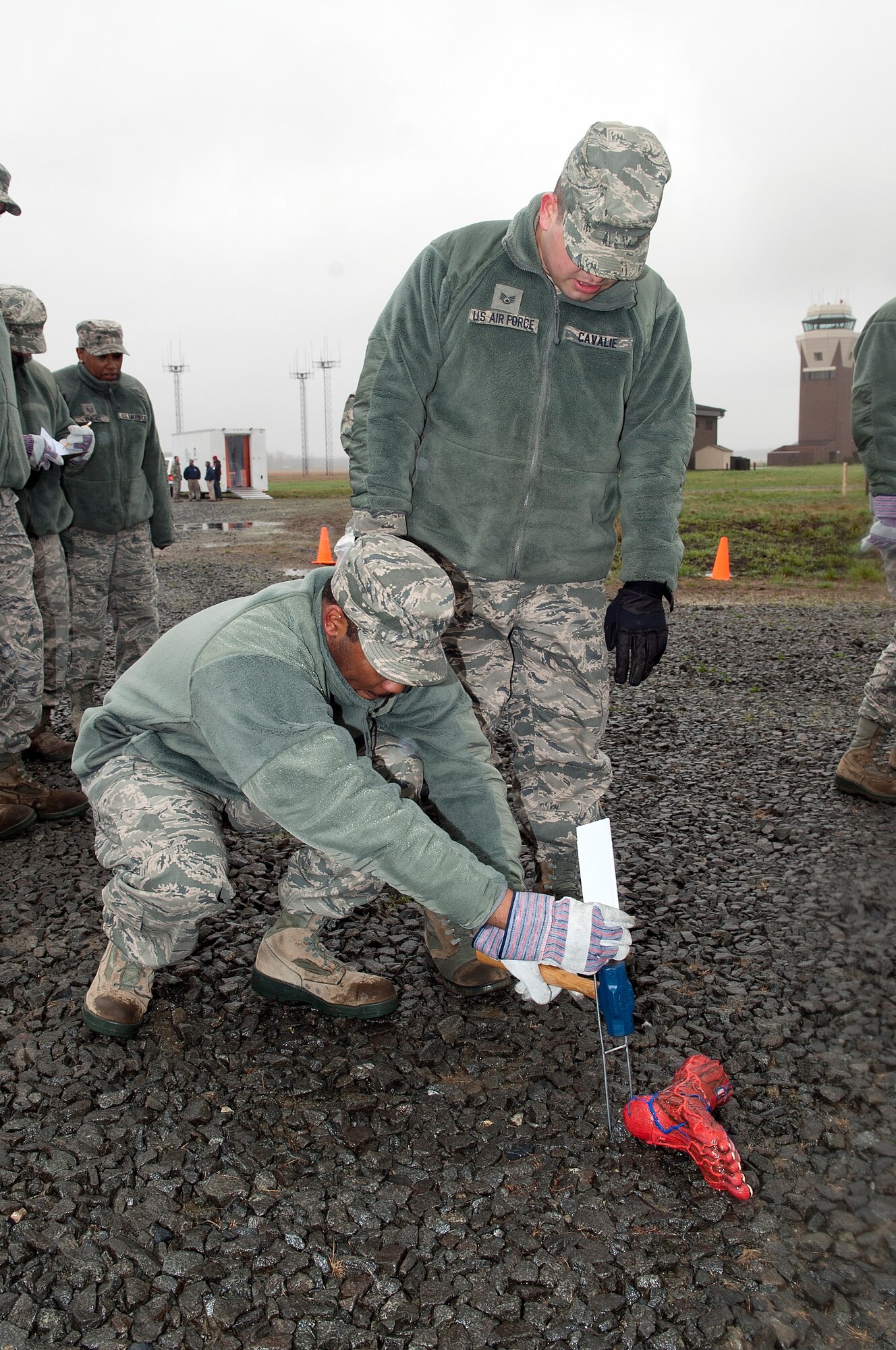 Members of the Joint Base McGuire-Dix-Lakehurst Search and Recovery team document simulated human remains found during the grid search of a major aircraft response exercise March 31. In this MARE, the base simulated two aircraft colliding midair during the open house and subsequently crashing at two sites—on and off base. (U.S. Air Force photo by Wayne Russell/Released)