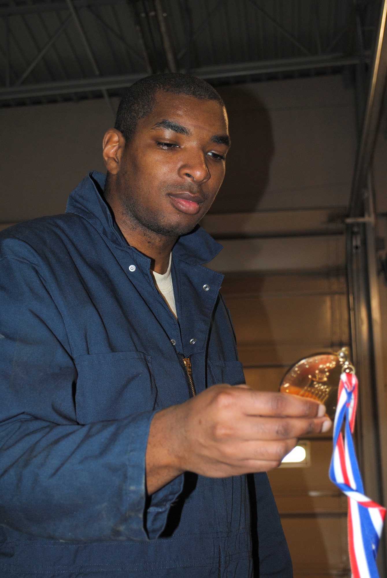 Senior Airman Tyrell Bridgeforth, 341st Maintenance Operations Squadron MAPS technician, looks at Colgan's congressional medal.  Bridgeforth was one of many members of Team Malmstrom that had the opportunity to see, touch and even feel Colgan’s medal.  (U.S. Air Force photo/Airman 1st Class Cortney Paxton)