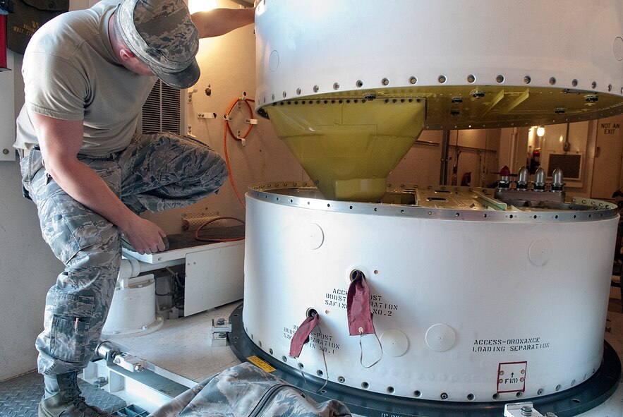 Tech. Sgt. Tim Favreau, guides a new missile guidance set as it is mated with the propulsion system rocket engine of a Minuteman III missile in a 90th Missile Wing launch facility March 29. The new MGS extends the operational life of the missile. (U.S. Air Force photo by R.J. Oriez)