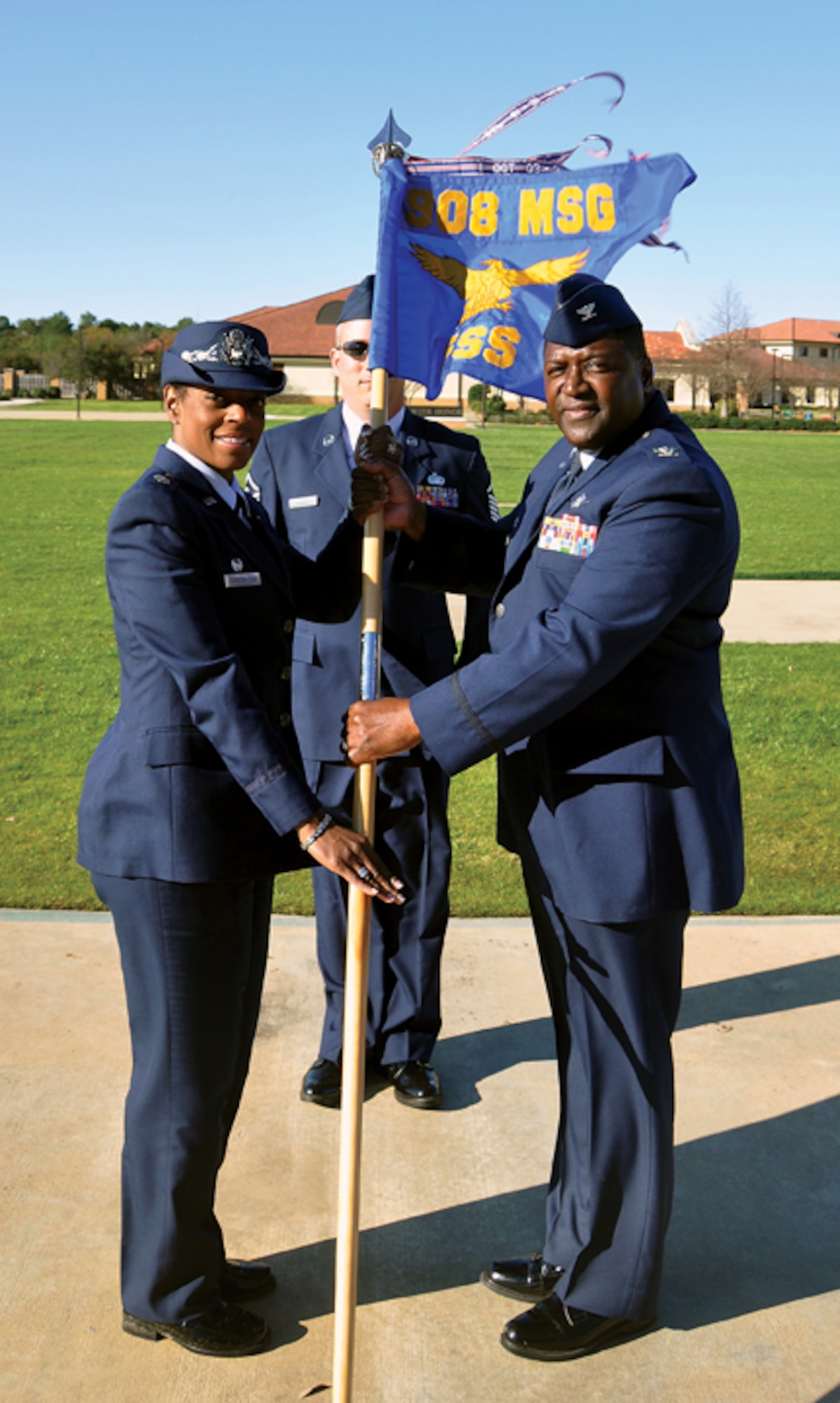 Lieutenant Colonel Constance Johnson-Cage recently assumed command of the 908th Force Support Squadron. Here', she accepts the squadron guidon from 908th Mission Support Group Commander Col. Pete Peterson. (Air Force photo by Tech. Sgt. Jay Ponder)