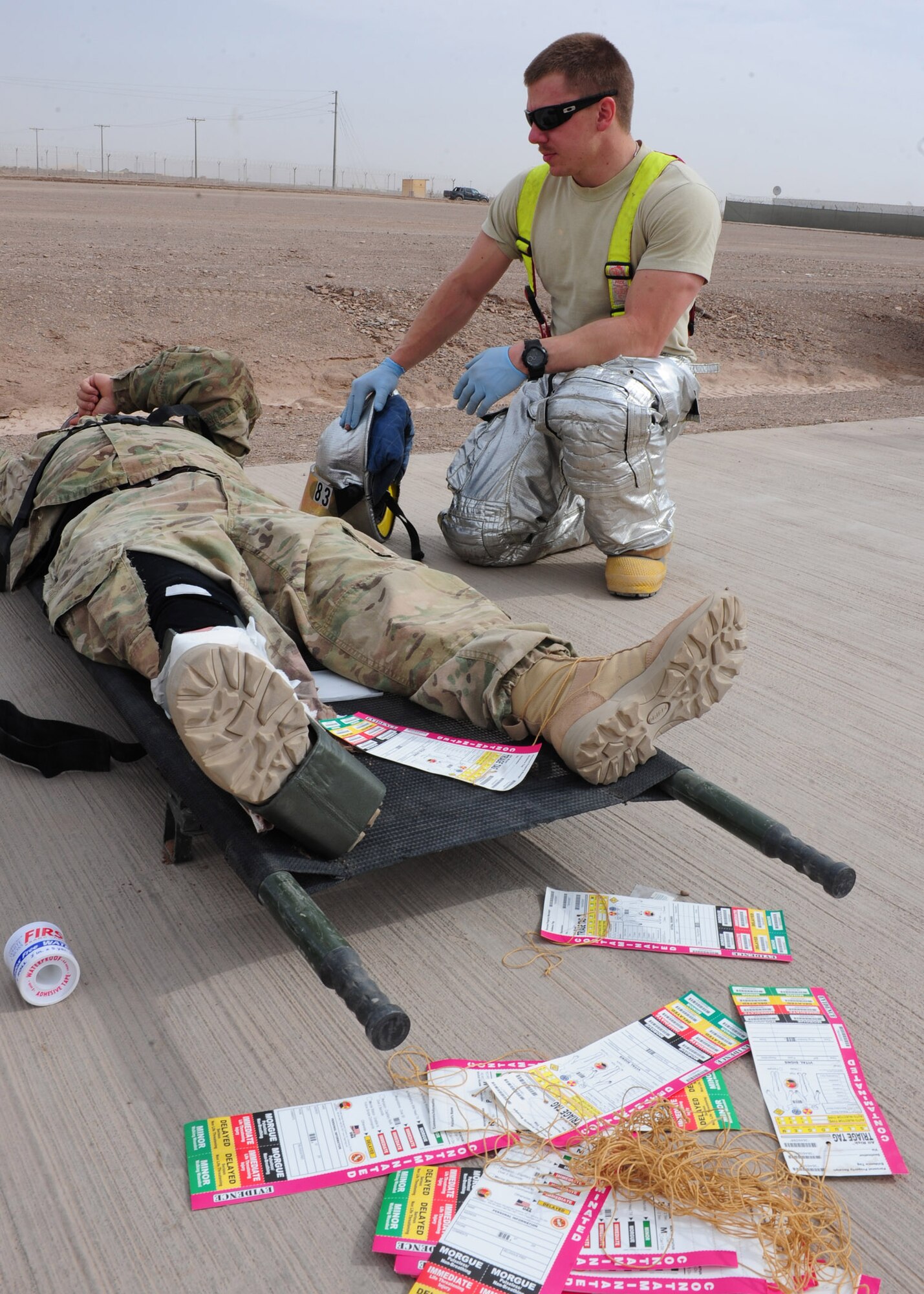 Senior Airman Cody Williams, a firefighter with the 838th Air Expeditionary Advisory Group, provides overwatch support to a patient injured in a simulated blast during a mass causality exercise at Shindand Air Base, March 25, 2012. Responders from various fire, force protection and medical facilities joined the 838th AEAG to develop a seamless response capability able to quickly respond to threats in and around Shindand. (U.S. Air Force photo by Staff Sgt. Nadine Y. Barclay)