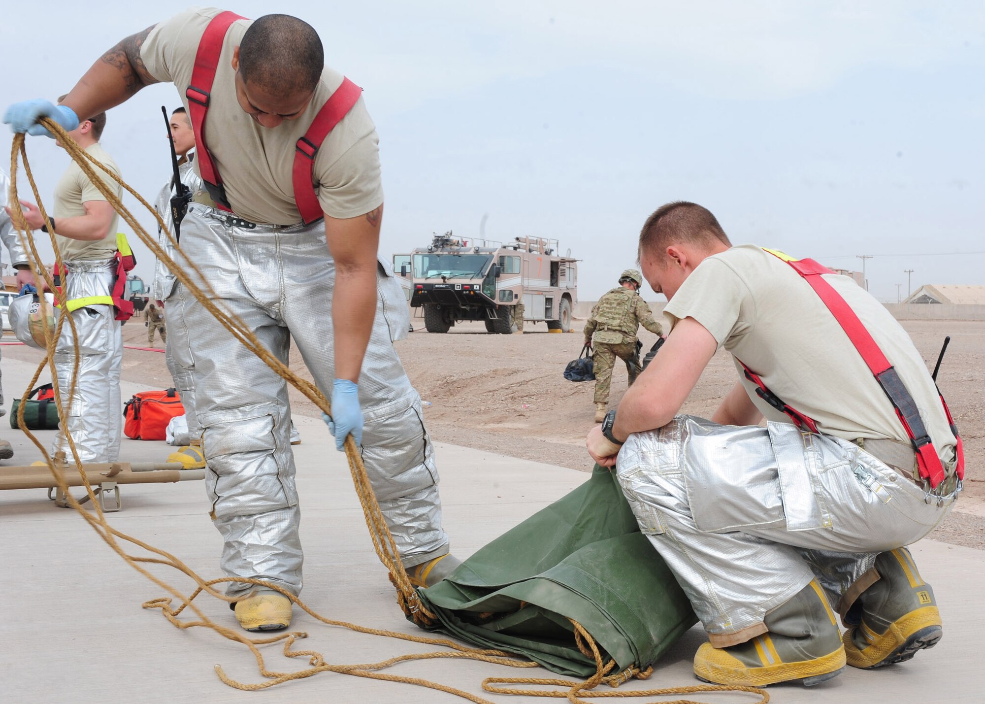 Firefighters with the 838th Air Expeditionary Advisory Group, pack away equipment and supplies used during a simulated attack that resulted in a mass causality exercise at Shindand Air Base, Afghanistan, March 25, 2012. Responders from various fire, force protection and medical facilities joined the 838th AEAG to develop a seamless response capability able to quickly respond to threats in and around Shindand. (U.S. Air Force photo by Staff Sgt. Nadine Y. Barclay)