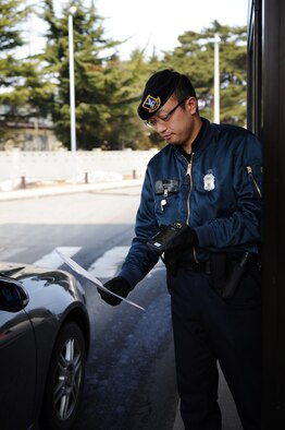 Masahito Sasakura, 35th Security Forces Squadron gate guard, scans a base pass at Misawa Air Base, Japan, March 30, 2012. Gate guards have the responsibility to ensure that only those with permission to access the base are being allowed in. By performing their job well, Airmen of the 35 SFS earned the title Air Force Outstanding Security Forces Medium Unit 2011. (U.S. Air Force photo/Airman 1st Class Kia Atkins/Released) 
