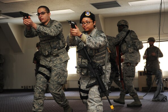 U.S. Air Force Airman 1st Class Nicholas Davis, left, and Staff Sgt. April Riddle, 35th Security Forces Squadron defenders, practice proper transition drills during High Risk Response Training at Misawa Air Base, Japan, March 30, 2012. In combat, if a primary weapon fails, the ability to quickly transition to a sidearm could mean the difference between life and death. Regular training exercises like this, gave 35 SFS Airmen the ability to develop the skills and knowledge that resulted in the squadron earning the Air Force Outstanding Security Forces Medium Unit 2011. (U.S. Air Force photo/Airman 1st Class Kia Atkins/Released) 
