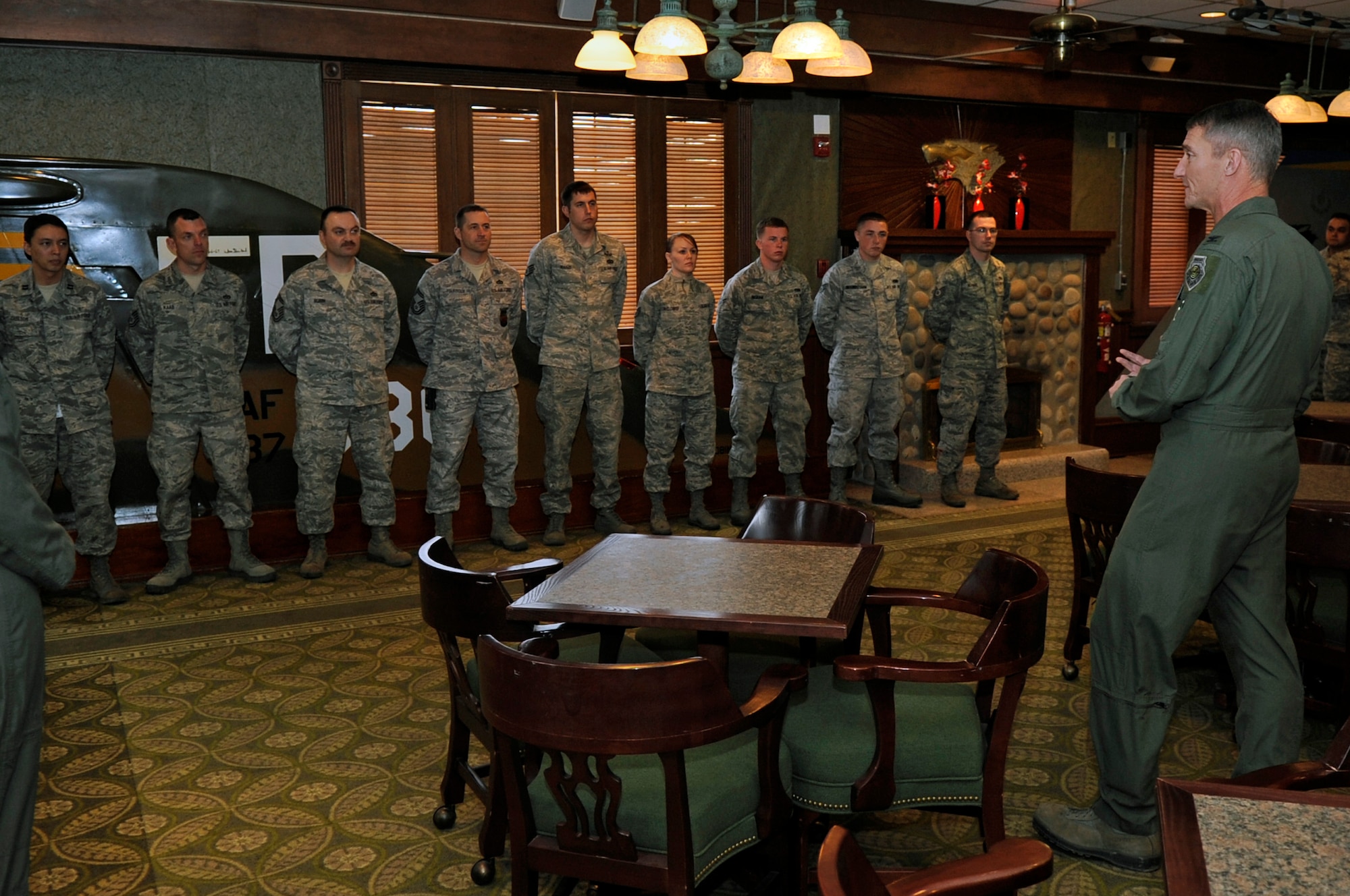 Col. Patrick McKenzie, 51st Fighter Wing commander from Osan Air Base, Republic of Korea, talks with Wolf Pack Airmen at the Loring Club, on Kunsan Air Base, ROK, April 6, 2012, who were instrumental to the emergency response efforts following an Air Force F-16 Fighting Falcon crash near Kunsan AB in March.
