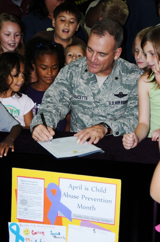 ANDERSEN AIR FORCE BASE, Guam – Brig. Gen. John Doucette, 36th Wing commander, signs a proclamation declaring April as Child Abuse Awareness Month while children from the Child Development Center watch April 6.  “Healthy Kids, Strong Families” is a topic that is being taught to the children and parents of Team Andersen, encouraging families to talk with each other and children to be active in sharing things with their parents. (U.S. Air Force photo/ Senior Airman Carlin Leslie)