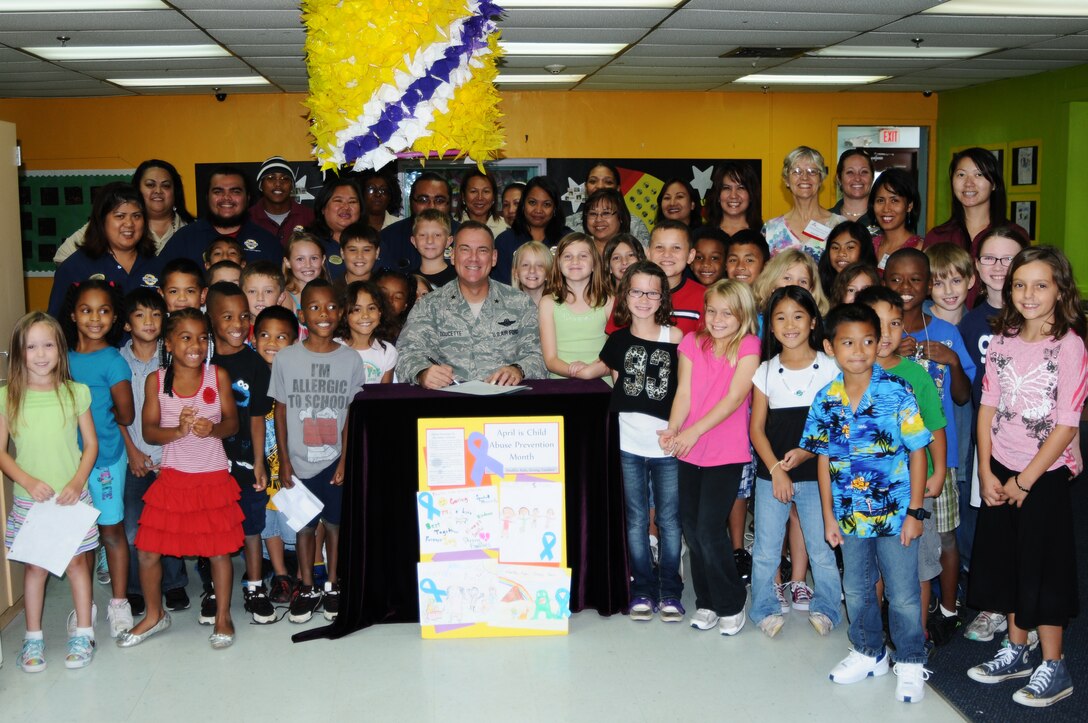ANDERSEN AIR FORCE BASE, Guam – Brig. Gen. John Doucette, 36th Wing commander, poses for a photo with faculty and children from the Child Development Center before signing the Child Abuse Prevention Month Proclamation April 6. “Healthy Kids, Strong Families” is a topic that is being taught to the children and parents of Team Andersen, encouraging families to talk with each other and children to be active in sharing things with their parents. (U.S. Air Force photo/ Senior Airman Carlin Leslie) 