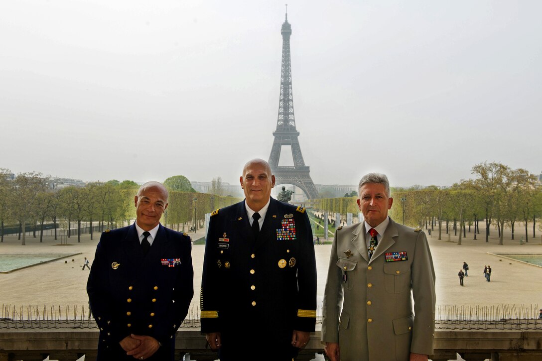 French Navy Vice Admiral Richard Laborde, left, the director of the Institute of Higher National Defence Studies and of Higher Military Training, U.S. Army Chief of Staff Gen. Raymond T. Odierno, center, and French Army Chief of Staff Gen. Bertrand Ract-Madoux, stand together for a photograph with the Eiffel tower as a backdrop during Odierno's visit to the École de Guerre [War College] in Paris, April 5, 2012.