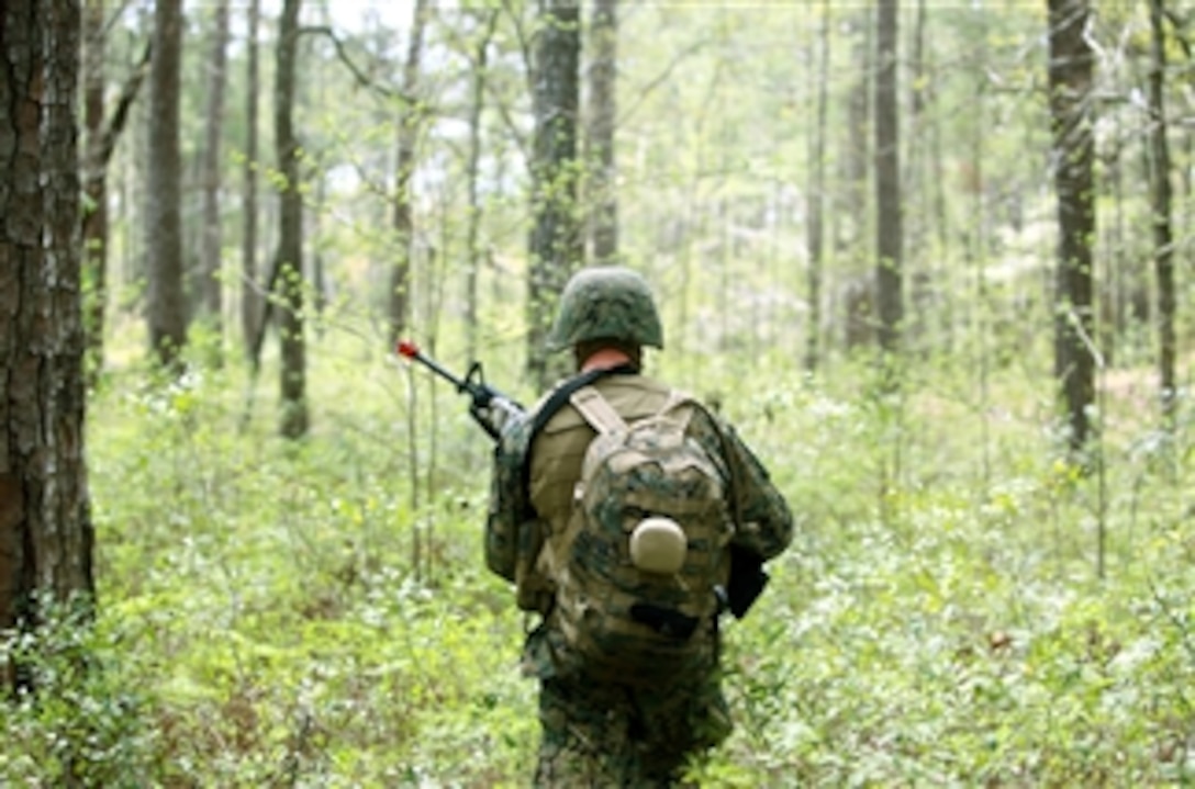 A U.S. Marine with Combat Logistics Regiment 25, 2nd Marine Logistics Group patrols through a forest during a field exercise at Marine Corps Base Camp Lejeune's Gun Position One in North Carolina on April 3, 2012.  The purpose of the exercise is to give Marines and sailors within the regiment an opportunity to enhance battle skills that they don't get to practice on a day-to-day basis.  