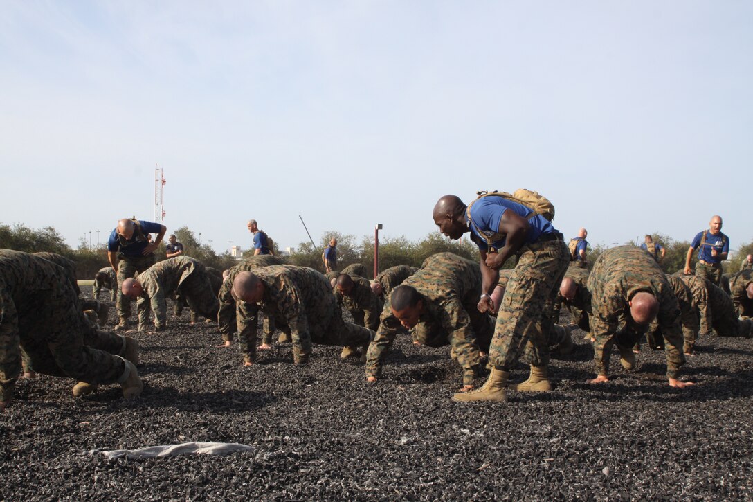 Sgt. Christian Hutson, drill instructor, Company I, motivates his recruits during their warm-ups April 6 aboard Marine Corps Recruit Depot San Diego. These warm-ups help increase the recruits' heart rate, simulating the stress endured in a combat environment. Co. I recruits learned lower body strikes which included knee strikes, kicks and stomps.