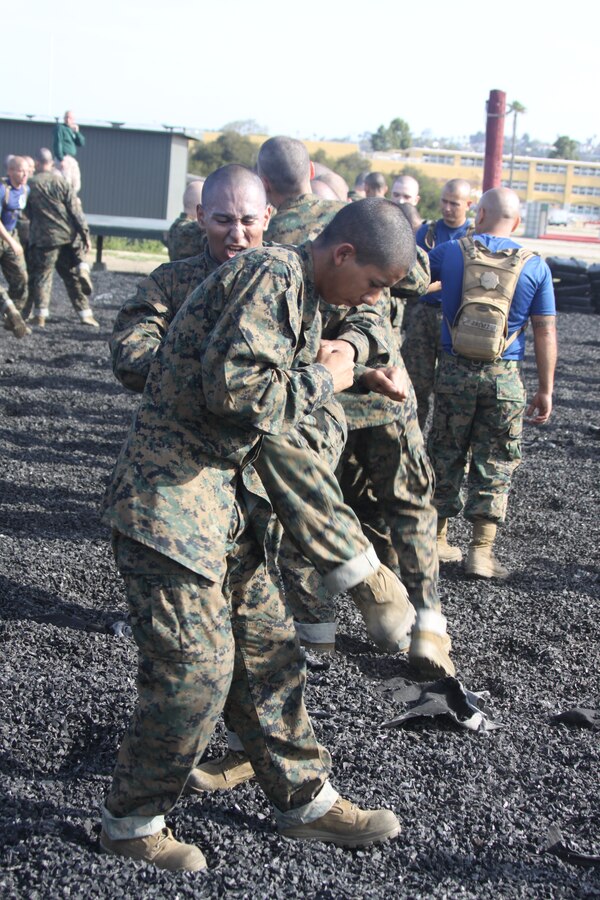 Company I recruits practice knee strikes on each other during Marine Corps Martial Arts Program training April 6 aboard Marine Corps Recruit Depot San Diego. Durinig third phase, Co. I will test to receive their tan belts. This is a graduation requirement for recruit training.