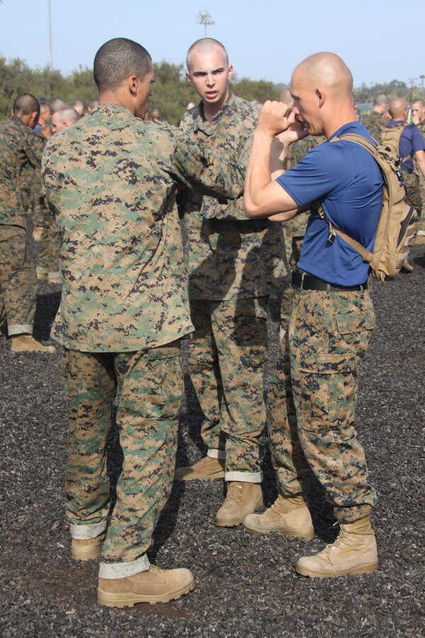 Company I drill instructors assist their recruits with the proper knee strikes April 2 during Marine Corps Martial Arts Program lower body strikes training aboard Marine Corps Recruit Depot San Diego. This is just some of the MCMAP training recruits endure while aboard the depot.