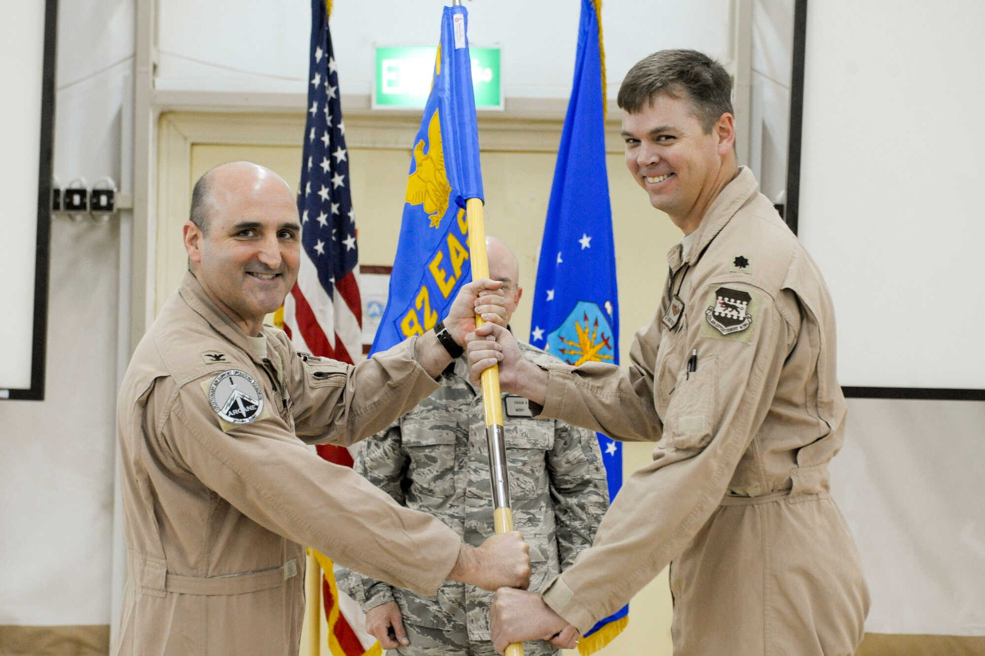 CAMP BUEHRING, KUWAIT -- Lt. Col. Jamie Conley, 82nd Expeditionary Air Support Operations Squadron commander, accepts the guidon from Col. Rodney Petithomme, 332nd Expeditionary Operations Group commander, during the unit’s activation ceremony here, April 6, 2012. The passing of the guidon signifies Conley’s official assumption of command. Petithomme is deployed from Osan Air Base, Korea, and is a native of Clovis, Calif. Conley is stationed here and is a native of Auburndale, Fla.  (U.S. Air Force photo by Staff Sgt. Joshua J. Garcia)