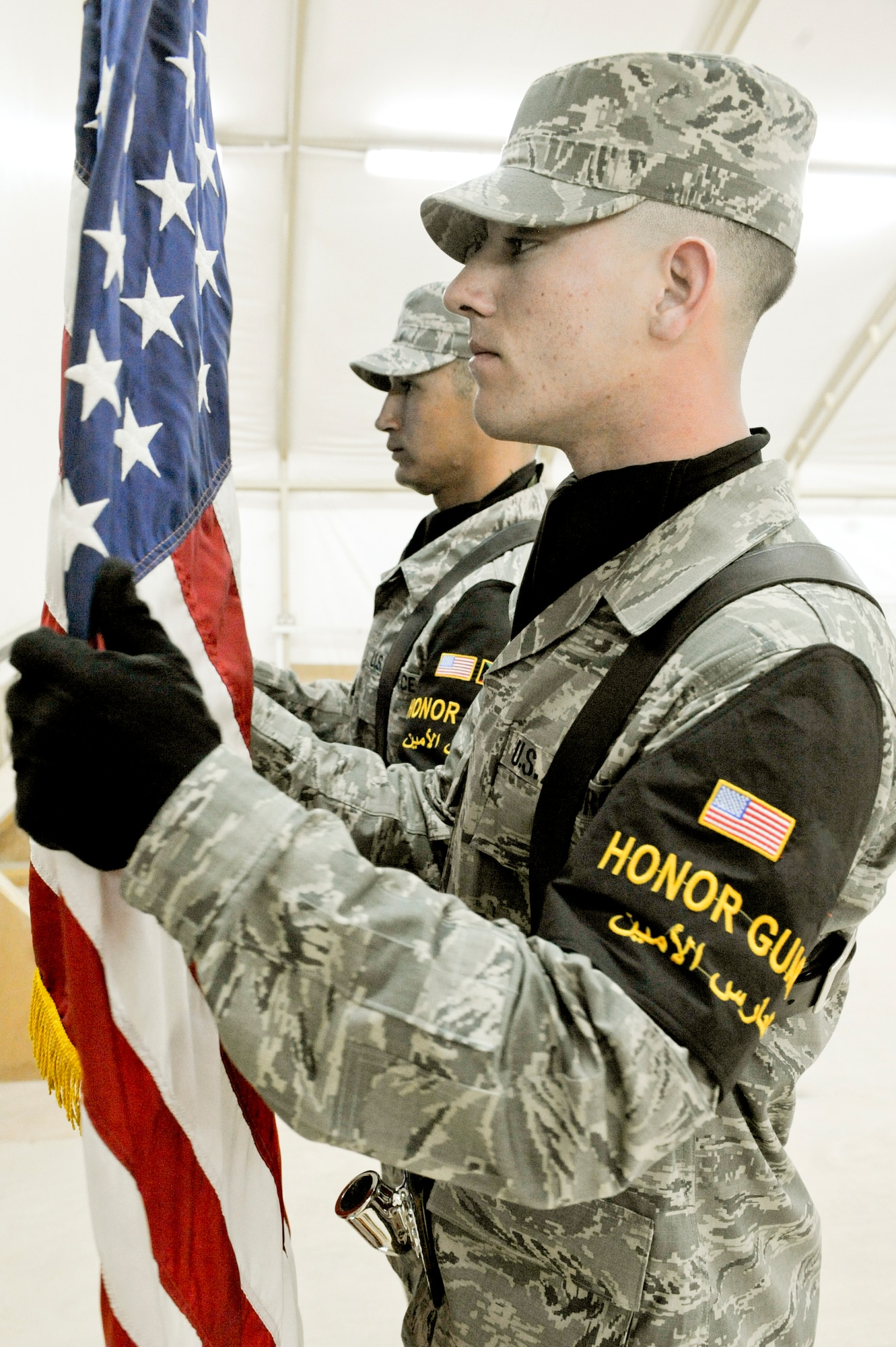 CAMP BUEHRING, KUWAIT -- Senior Airman Samuel Smith, and Tech. Sgt. Robert Cordova, 332nd Air Expeditionary Wing honor guard post the colors during the 82nd Expeditionary Air Support Operations Squadron activation ceremony here, April 6, 2012. Smith is deployed from Nellis Air Force Base, Nev. and is a native of Brunswick, Maine. Cordova is deployed from Dyess Air Force Base, Texas, and is a native of San Jose, Calif. (U.S. Air Force photo by Staff Sgt. Joshua J. Garcia)