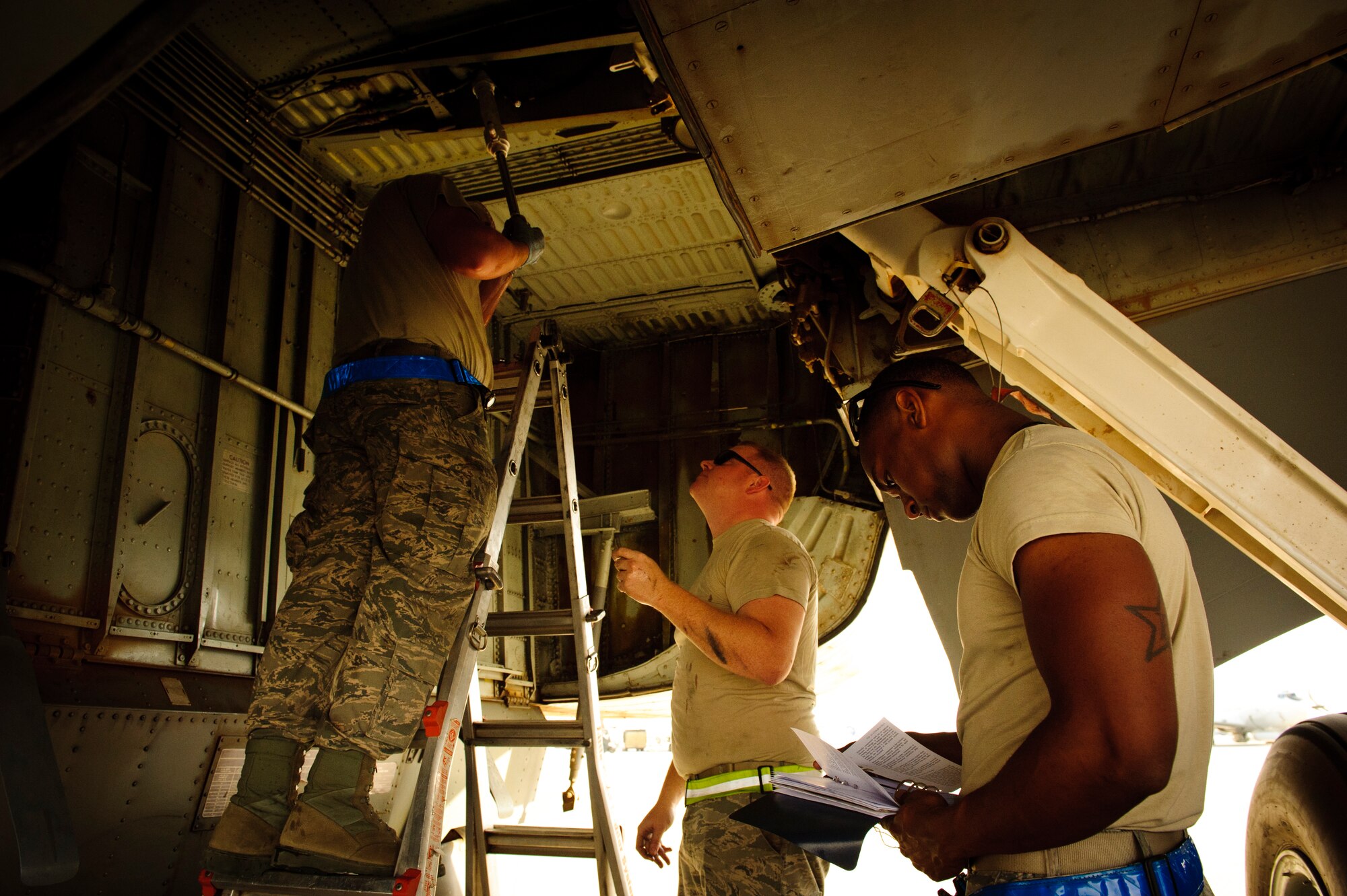 SOUTHWEST ASIA – Airman 1st Class Johnathan Holmes, Tech. Sgt. Adam Jensen, and Senior Airman Benjamin Guthrie, 340th Expeditionary Aircraft Maintenance Unit hydraulics specialists, work together to replace the side strut actuator for the main landing gear on a KC-135 Stratotanker here April 4. The KC-135, which was introduced to the Air Force inventory in 1957, is a relatively-low maintenance aircraft that is expected to be a part of the current fleet until 2040. (U.S. Air Force photo/Staff Sgt. Nathanael Callon)