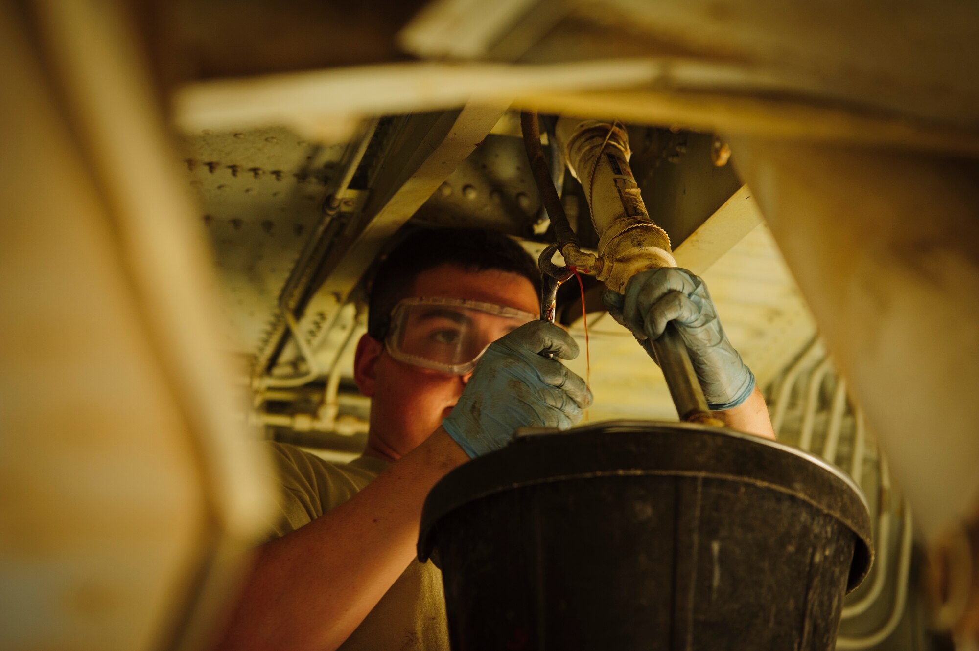 SOUTHWEST ASIA – Airman 1st Class Johnathan Holmes, 340th Expeditionary Aircraft Maintenance Unit hydraulics specialist and native of Hampden, Maine, removes a hydraulic line attached to the side strut actuator for the main landing gear on a KC-135 Stratotanker here April 4. The hydraulics system must be de-pressurized prior to making any adjustments to the system. (U.S. Air Force photo/Staff Sgt. Nathanael Callon)
