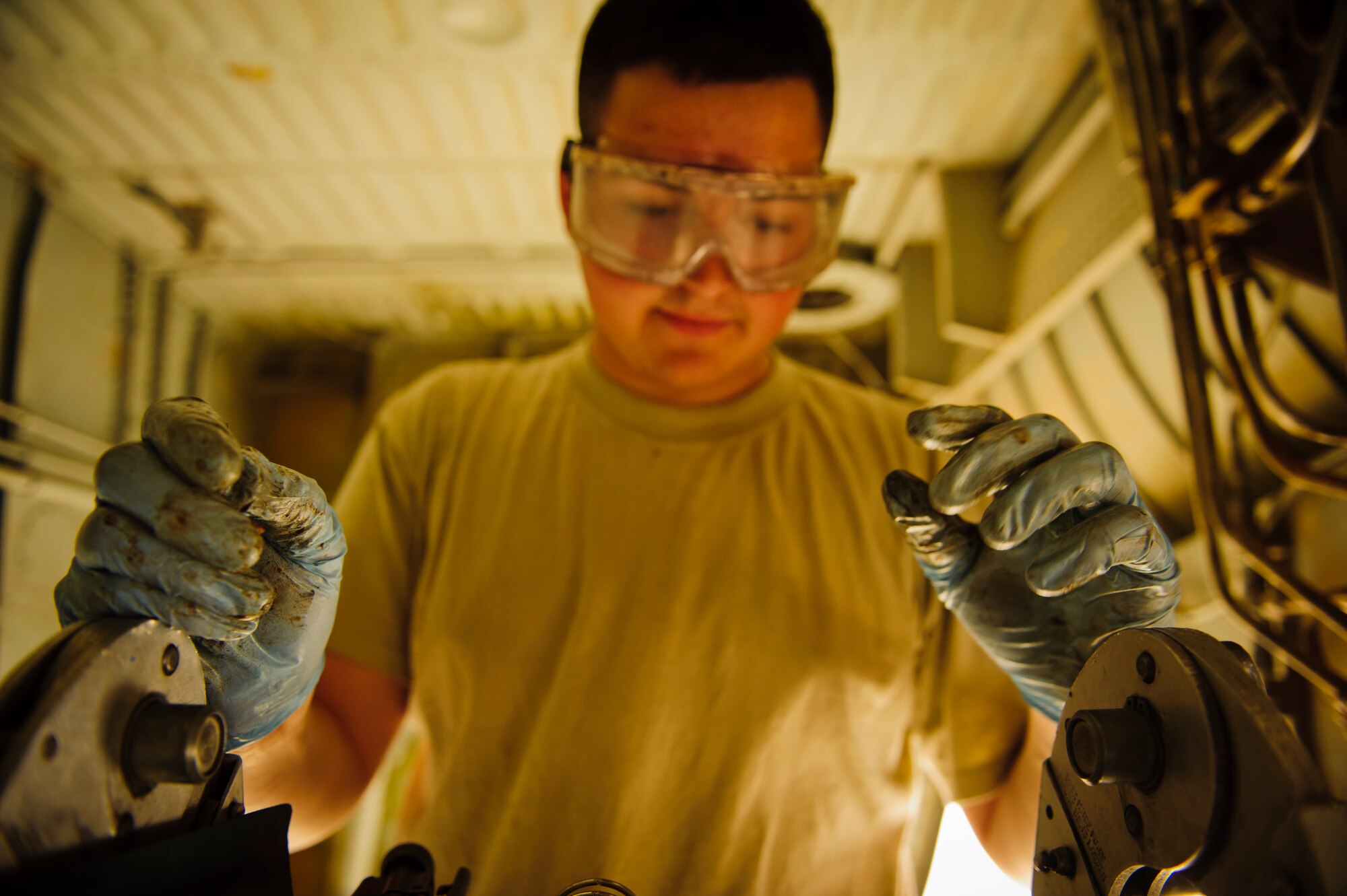 SOUTHWEST ASIA – Airman 1st Class Johnathan Holmes, 340th Expeditionary Aircraft Maintenance Unit hydraulics specialist and native of Hampden, Maine, reviews his technical order for performing maintenance on the side strut actuator for the main landing gear on a KC-135 Stratotanker here April 4. The technical order provides step-by-step procedures for performing maintenance on an aircraft. (U.S. Air Force photo/Staff Sgt. Nathanael Callon)