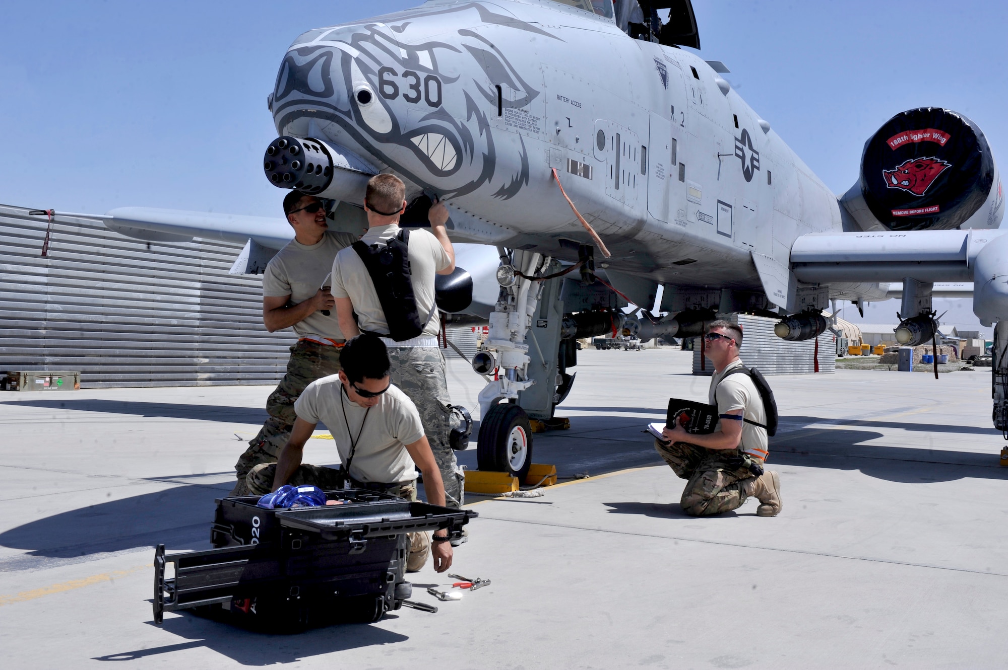 A 455th Expeditionary Aircraft Maintenance Squadron crew works as a team repairing an A-10 Thunderbolt at Bagram Airfield, Afghanistan, April 6, 2012. The 455th EAMXS is responsible for repairing and maintaining military aircraft on Bagram as well as performing preventative maintenance inspections. (U.S. Air Force photo/Airman 1st Class Ericka Engblom)