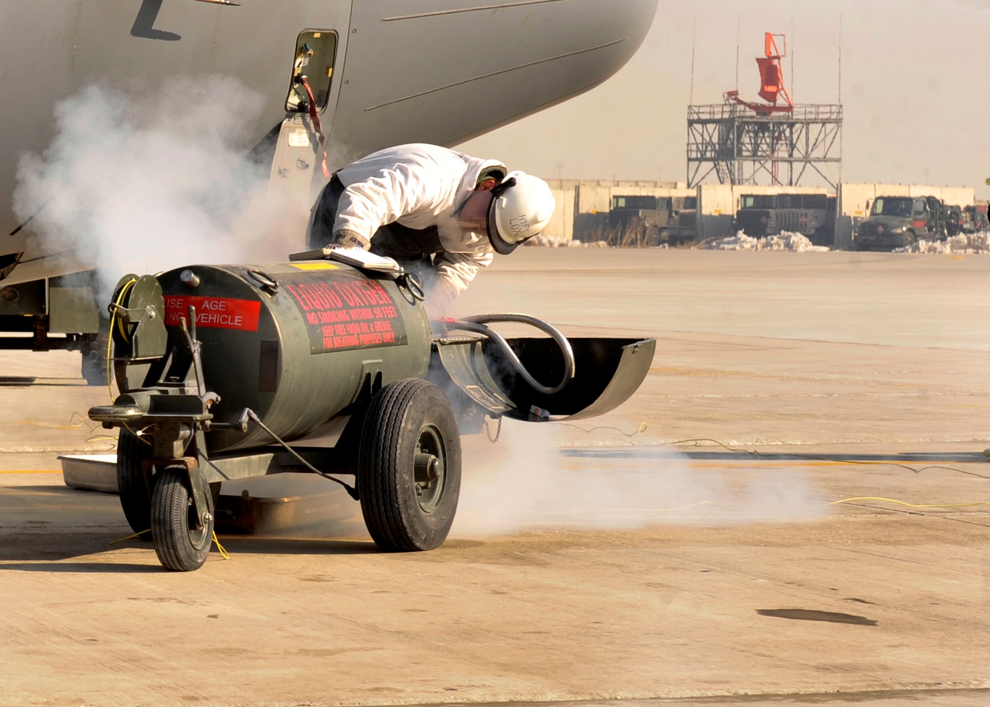 A 455th Expeditionary Aircraft Maintenance Squadron aircraft maintainer adds liquid oxygen to an EC-130 aircraft at Bagram Airfield, Afghanistan, Jan. 2011. The 455th EAMXS is responsible for preparing military aircraft on Bagram for flight and returning them to a mission-ready state once they land. (U.S. Air Force photo/Airman 1st Class Ericka Engblom)