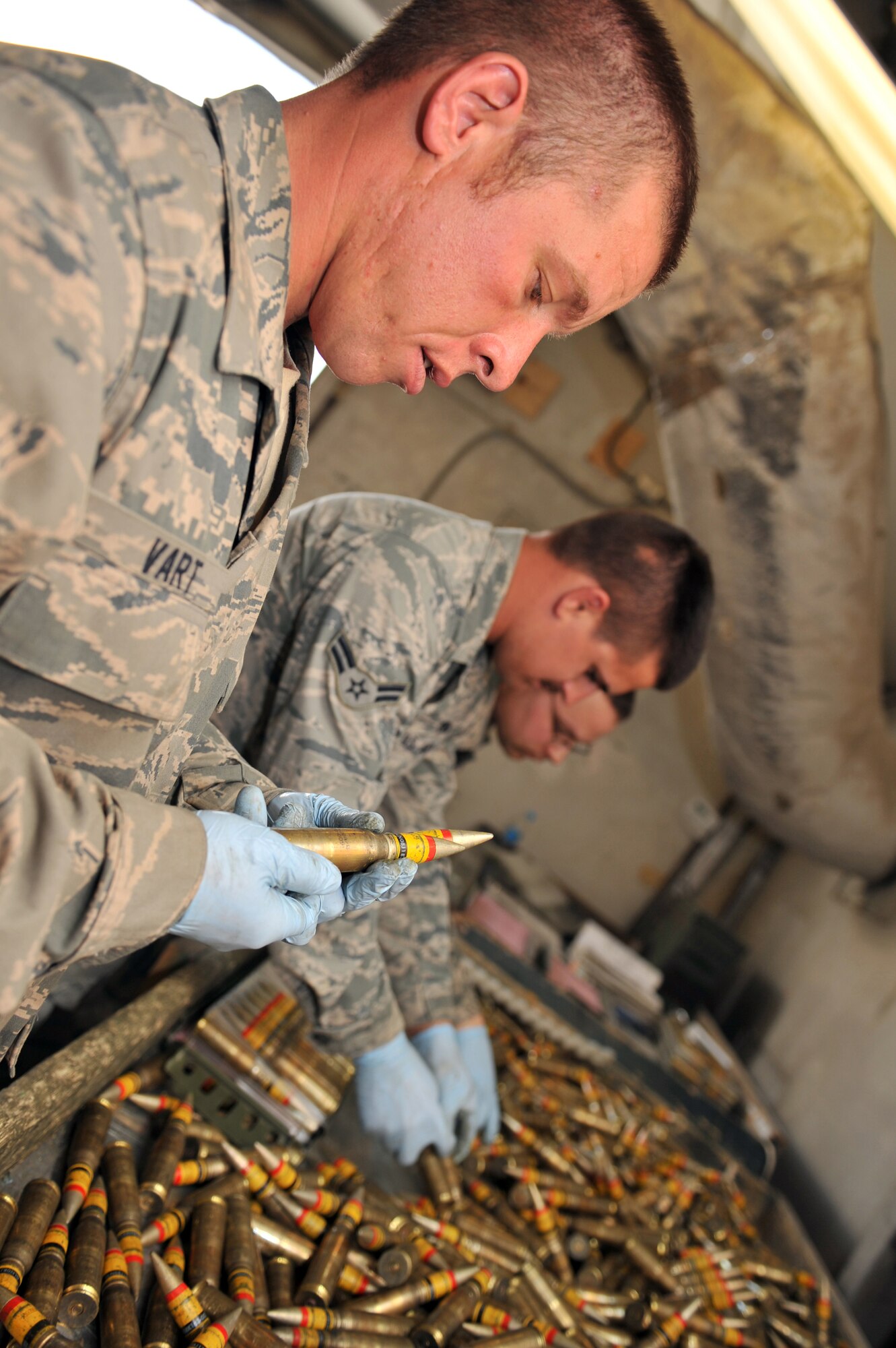 Staff Sgt. Glen Vart, 455th Expeditionary Maintenance Squadron Ammunition Supply Point technician, inspects 20 mm rounds to ensure they are serviceable at Bagram Airfield, Afghanistan, March 23, 2011. All ammunition must be inspected before being loaded to avoid deficient-round mishaps. (U.S. Air Force photo by Senior Airman Sheila deVera)